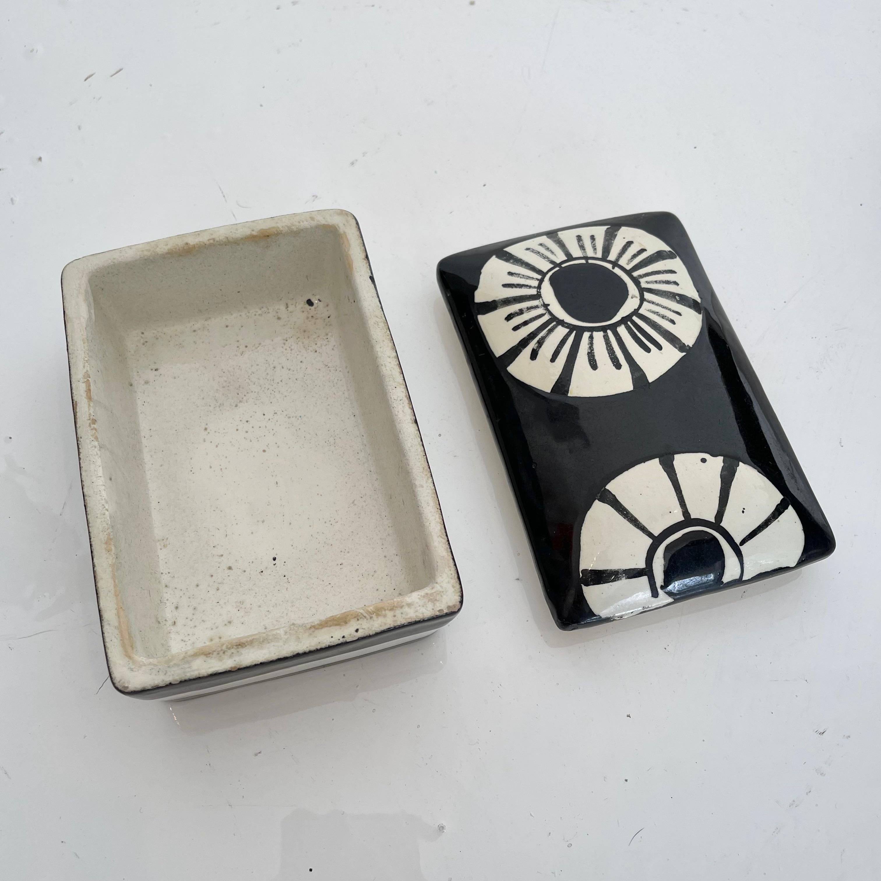 Elegant ceramic box made in Italy, circa 1970s. Black and white color theme with white flowers. Great condition. Perfect stash box or tabletop object. Marked Made in Italy on underside.