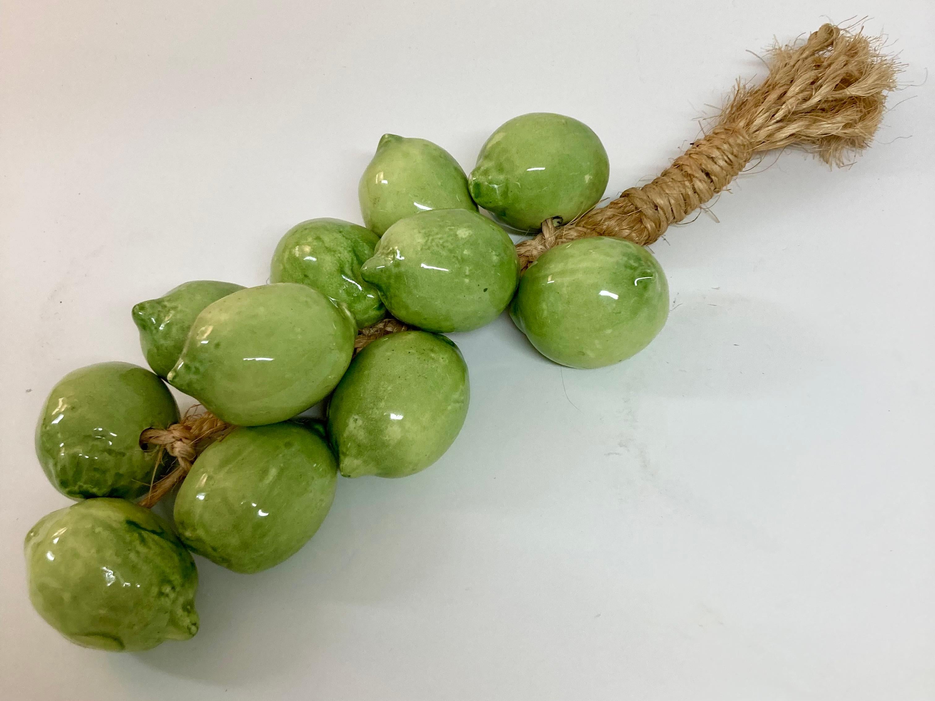 Magnifiques citrons verts en céramique italienne émaillée sur une corde en paille. Fabuleuse pièce d'art pour votre maison.