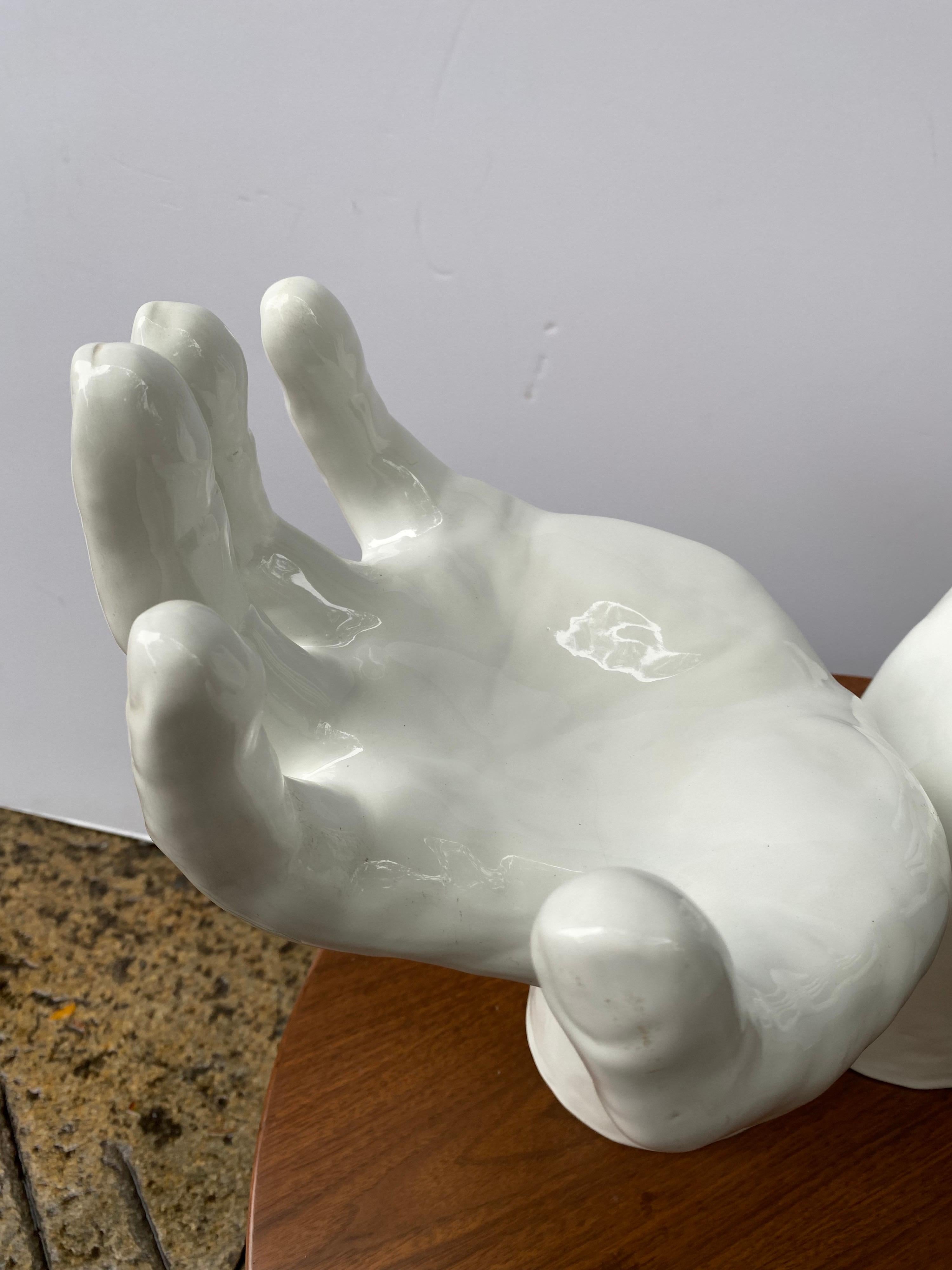 white ceramic hand sculpture