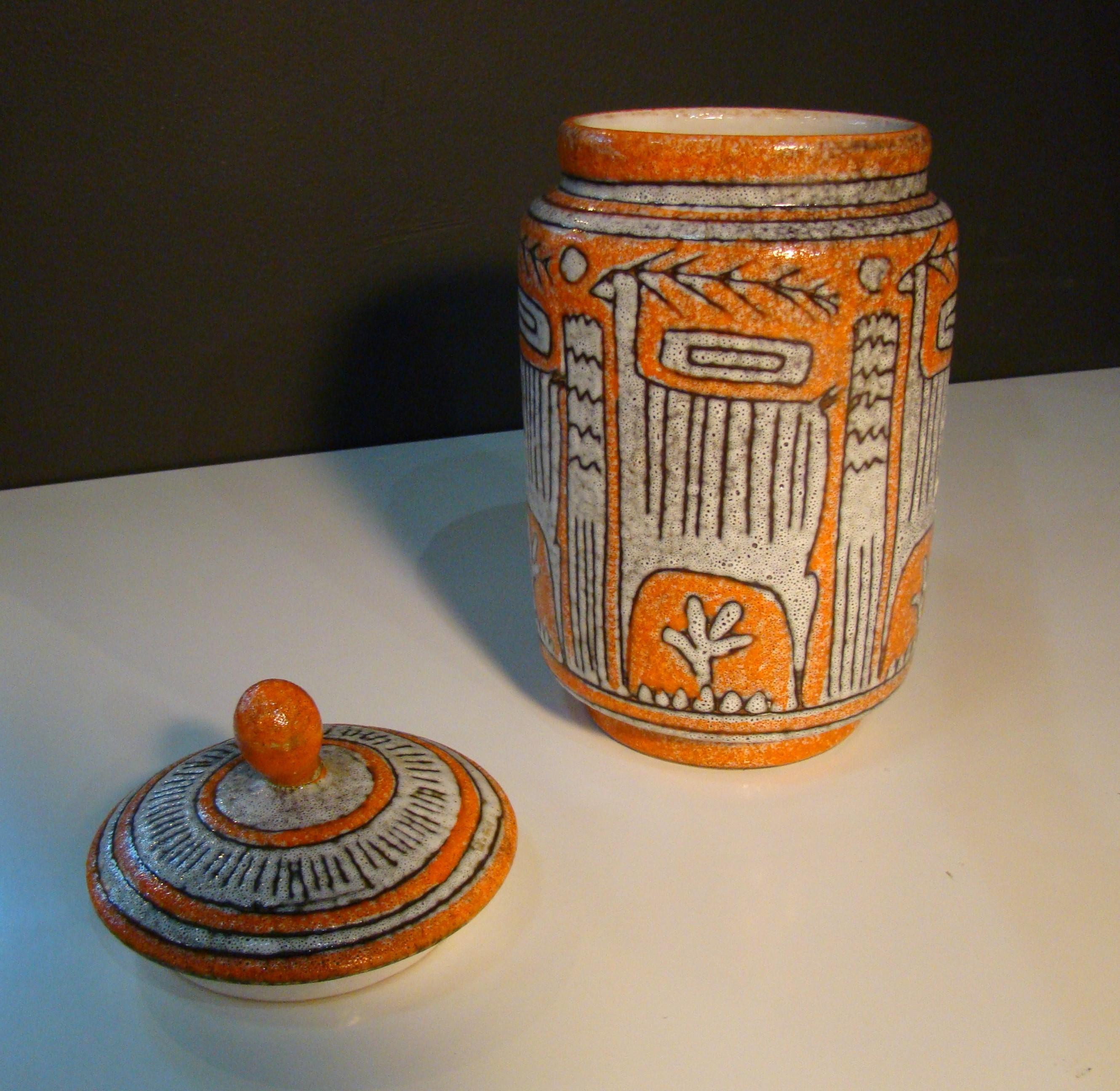Unsigned but with many earmarks of the lava glazed works with linear geometric glyphic symbols by Guido Gambone. Beautifully textured, orange on white, masterfully glazed jar with Gambone 'style' glyphics and lid that has a previous repair to the