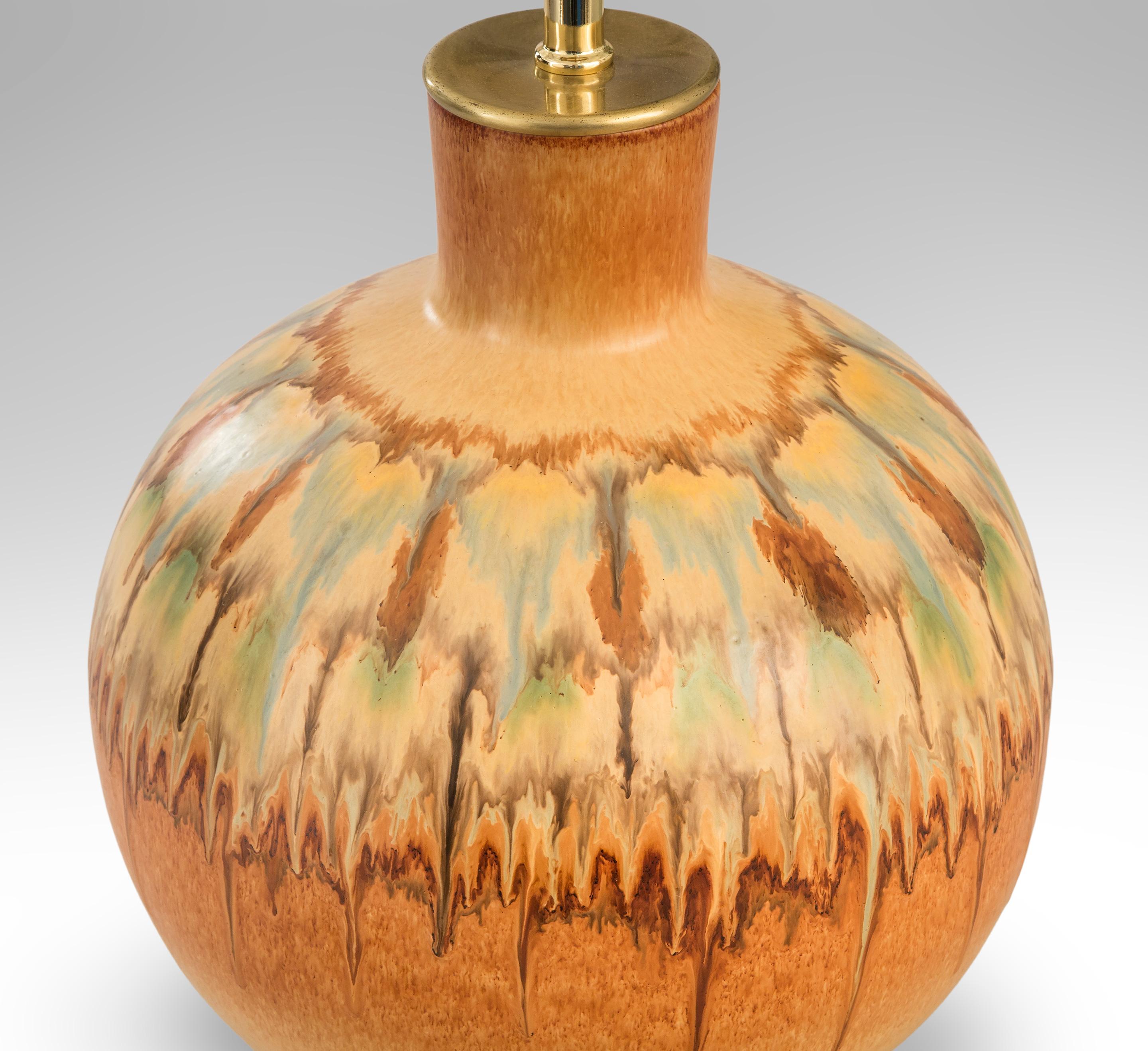 An Italian ceramic lamp by Bertoncello,
circa 1970
A lamp of elegant form with vibrant color and pattern and a stunning drip glaze. The cylindrical neck above a perfect sphere glazed with abstract bands of color and pattern.
Great condition,