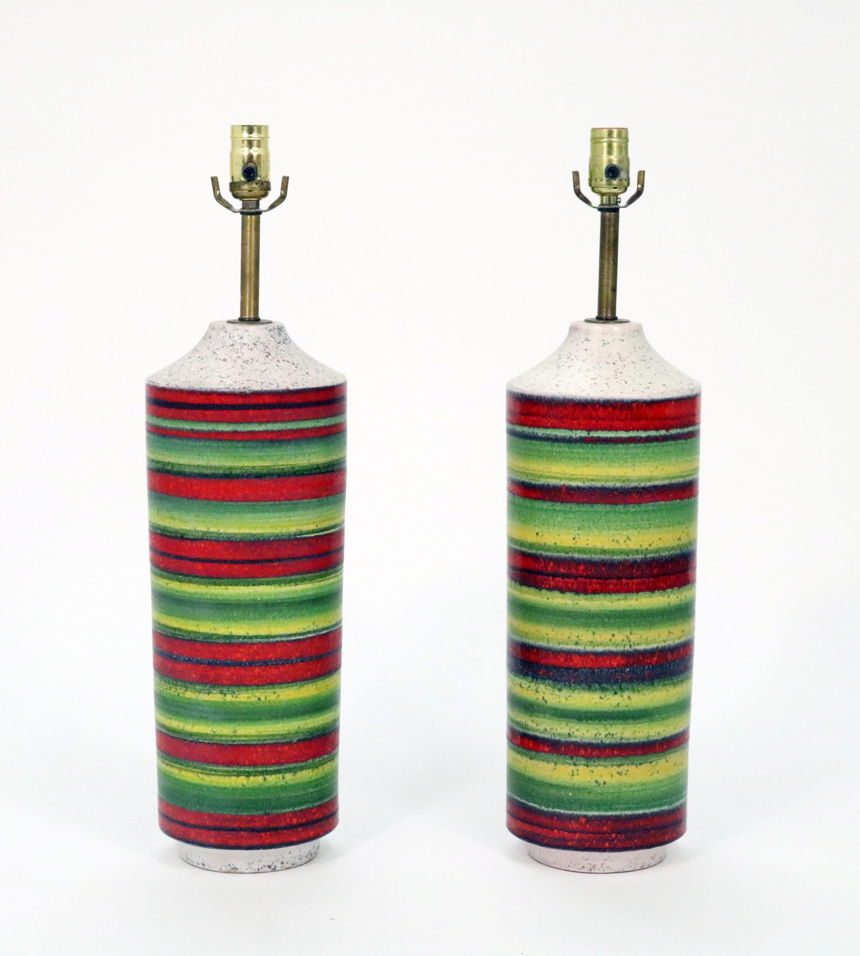 A gorgeous pair of mid-century Italian ceramic lamps by Alvino Bagni for Bagni Ceramiche, imported to the U.S. by Raymor. Brilliant reds, greens, yellows and black on a sand ivory palette.

Original shades. Can be shipped with or without