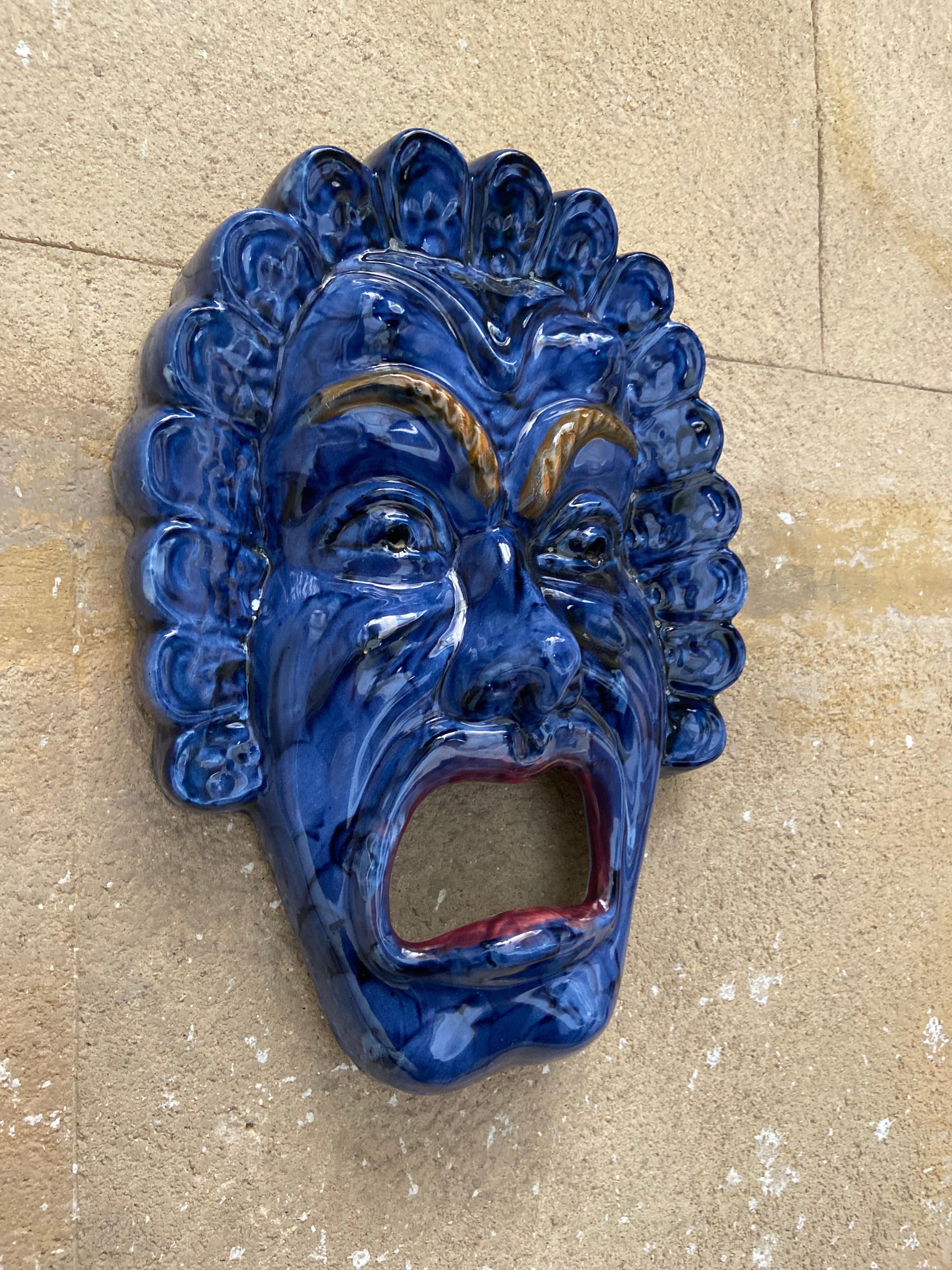 Grace your wall with this striking ceramic mask—an exquisite piece of art reminiscent of 