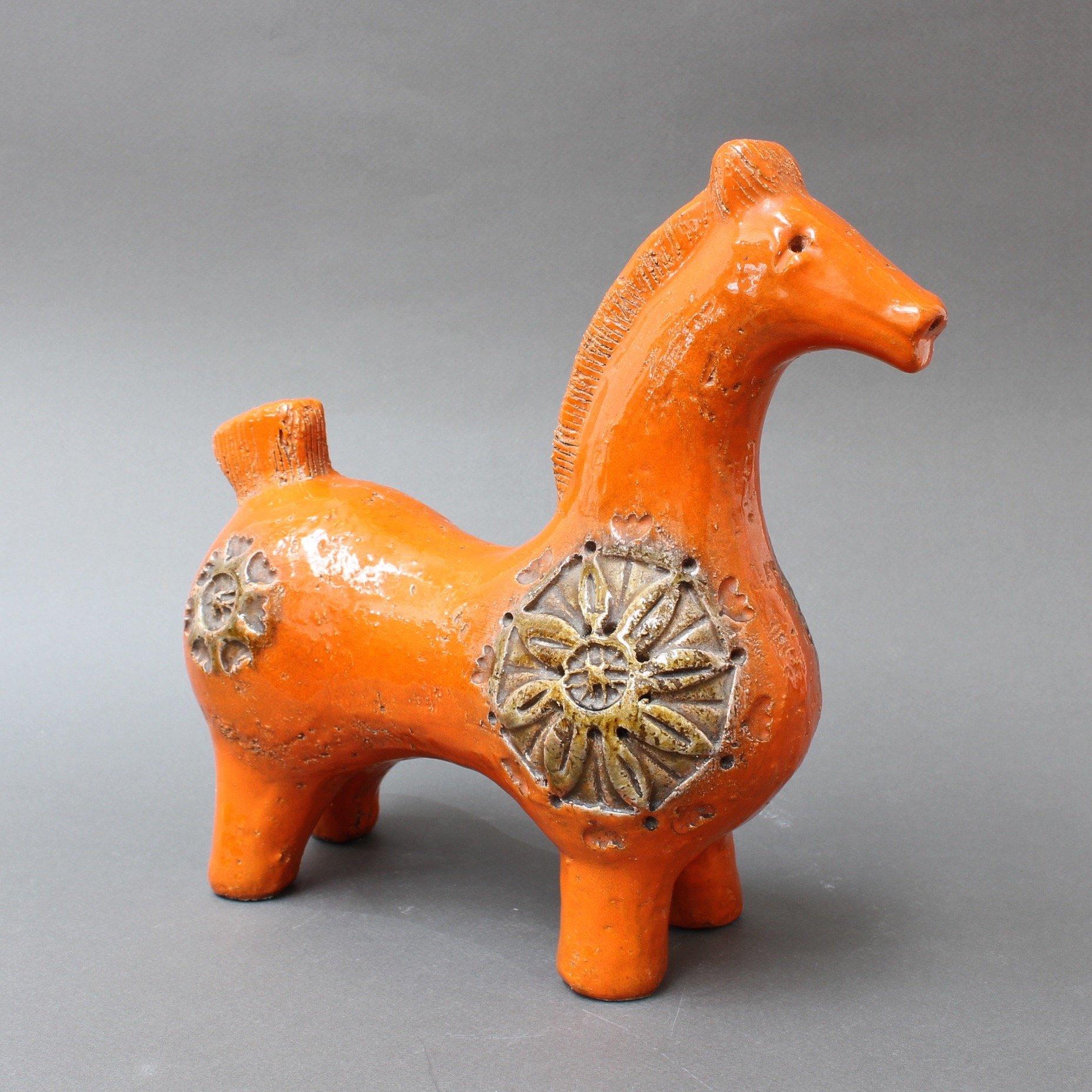 Italian ceramic orange horse by Aldo Londi for Bitossi, circa 1960s. A very iconic vintage design, decorated parade horse with sunflower motifs in 'Hermès orange'. Weighty and substantial, the piece will be a wonderful addition to your home or work