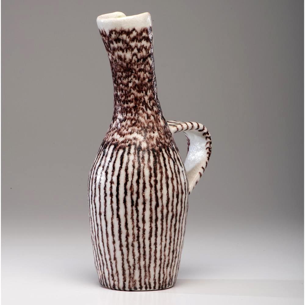 A large sculptural stoneware pitcher by Italian ceramic artist and designer Guido Gambone (1909-1969), circa 1950s. This vessel takes an elegant sculptural form from the Classic antiquity form, seen in both Greek and Persia. An elongated and