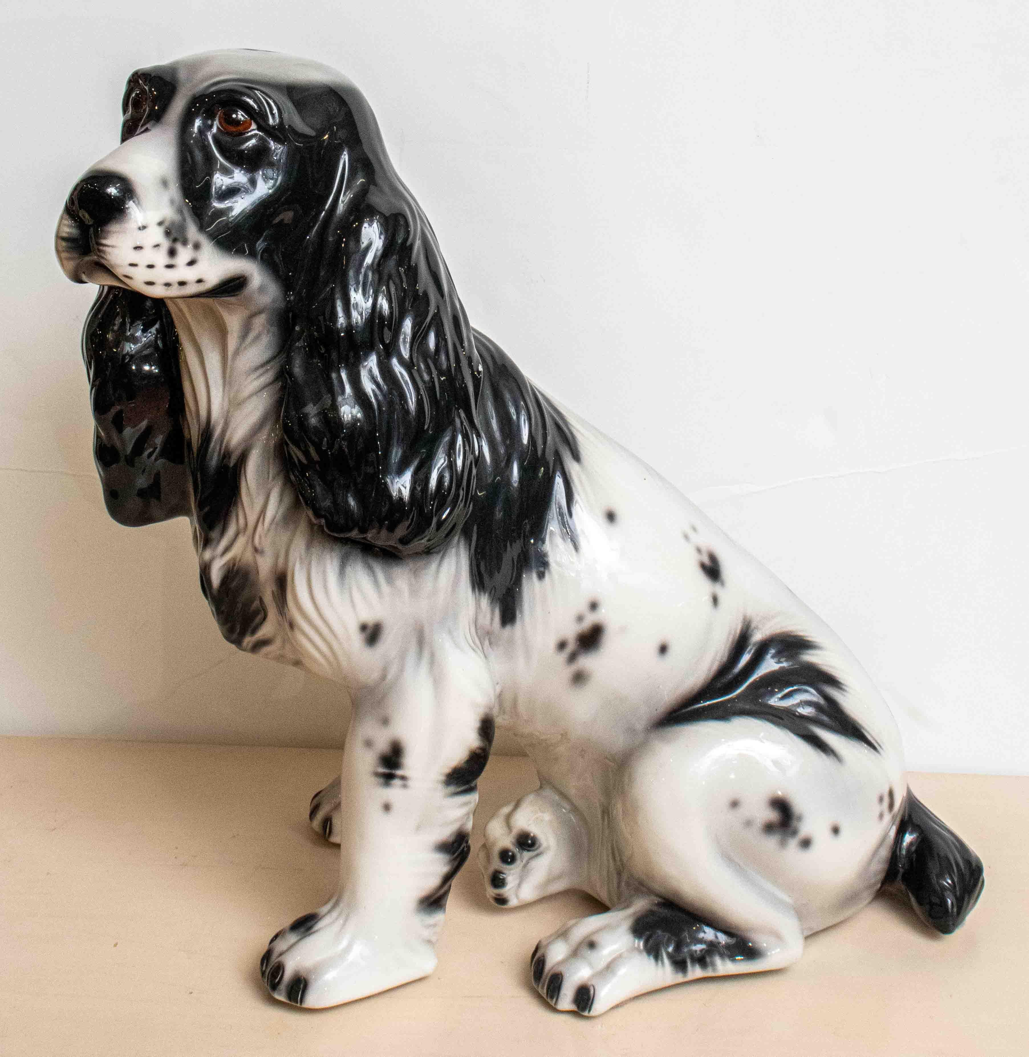 Charming 1950s Italian ceramic dog of a spaniel. Beautiful glazed black and white coloration. Nice details on the face and body.