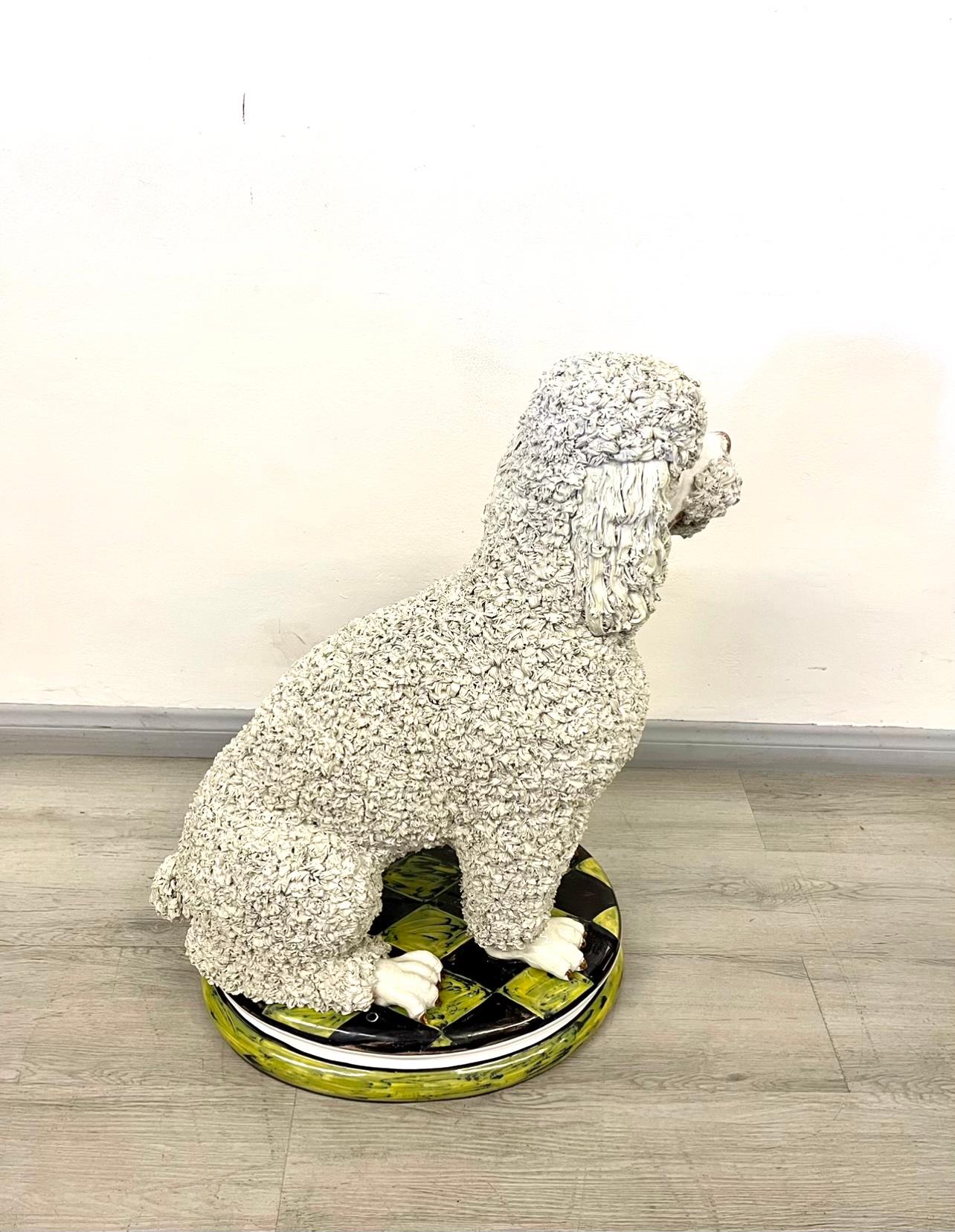 A beautiful Italian ceramic white poodle “Spaghetti” dog sculpture. A very well done sculpture. No cracks or chips. The Italian ceramic stand on a harlequin pattern base painted with a nice green and black color. A wonderful sculpture to decorate