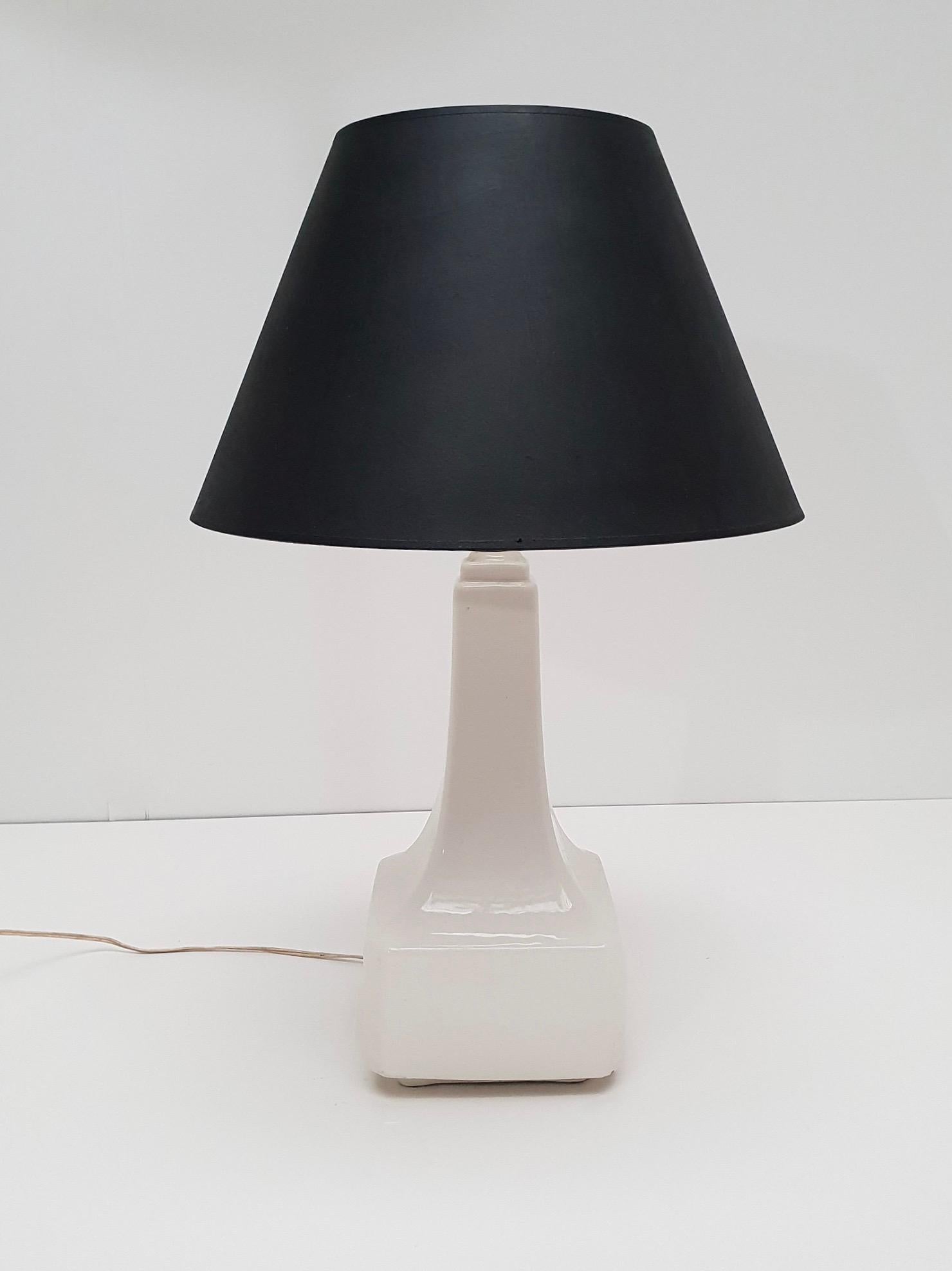 Wonderful ceramic table lamp in white glaze. It is signed on the side with a sticker 