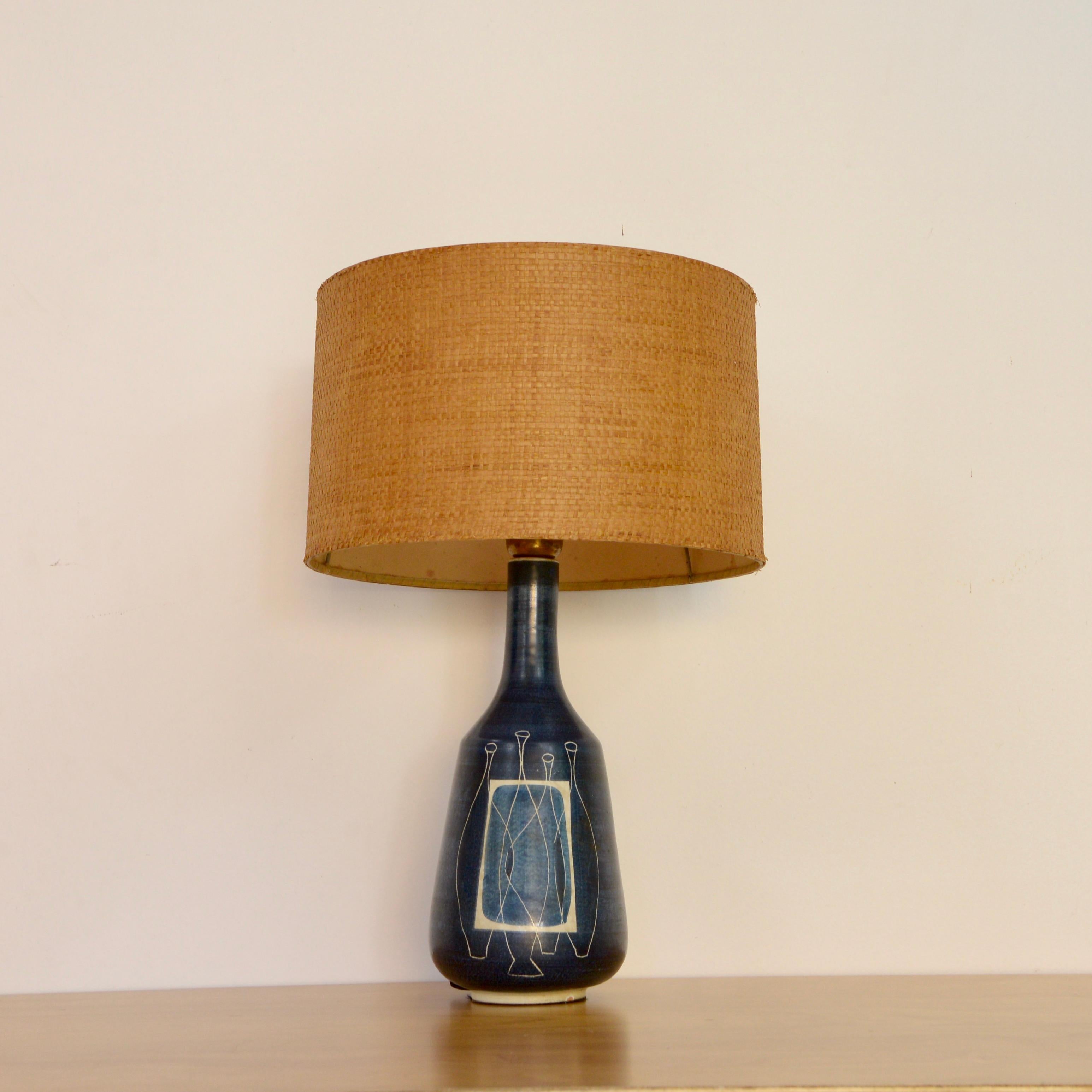 Vintage 1950s ceramic Italian table lamp with Sgraffito decoration in possibly indigo or lapis lazuli blue and rattan lamp shade. Fully rewired with a single E12 candelabra based socket, ready to be used in the USA. Measurements:
Height