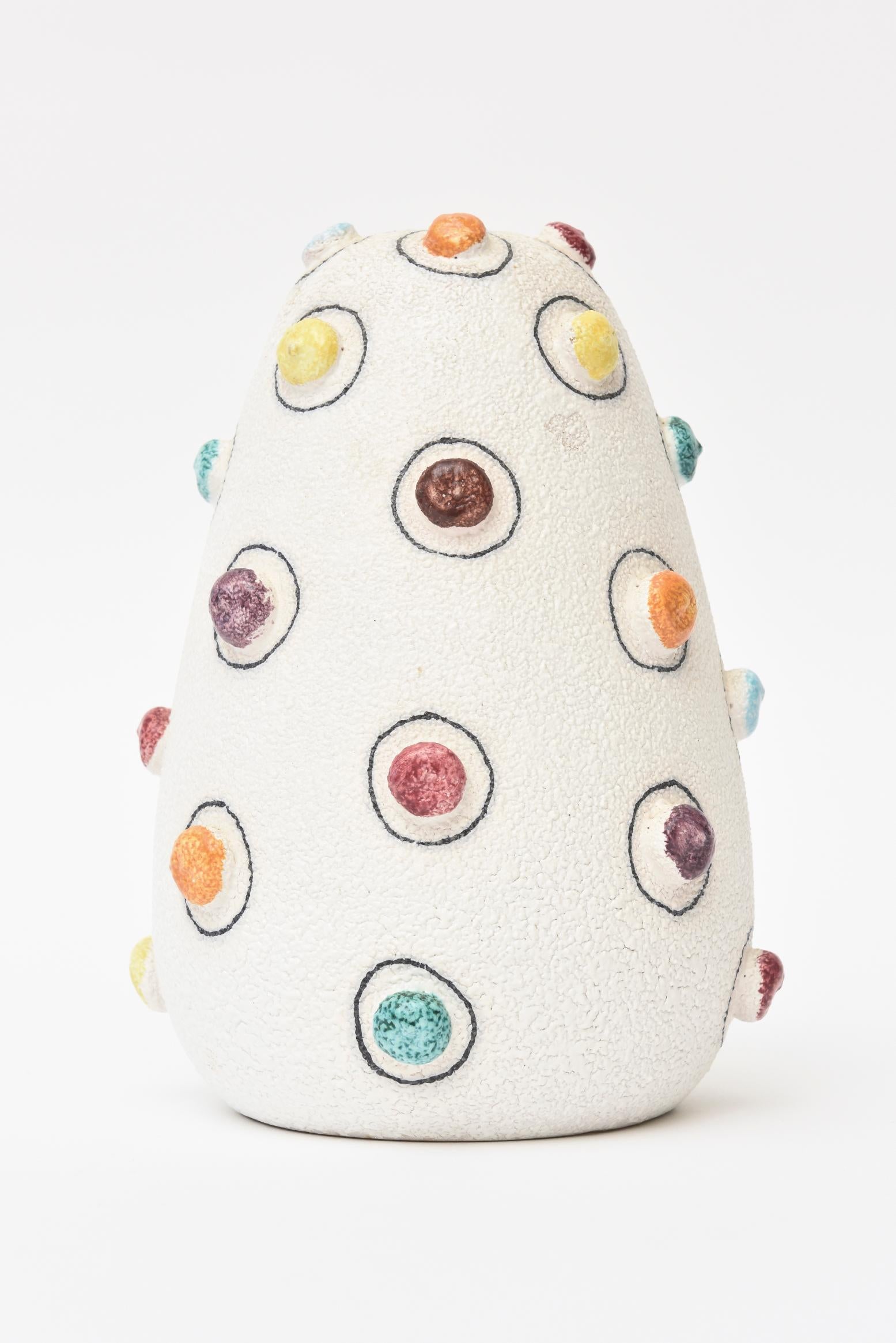 This colorful and happy dot like Italian textural studio pebbled ceramic vase / vessel / object brings sunshine into your home. The small round appendages of varying colors create a dot like pattern throughout. They are all outlined in black in a