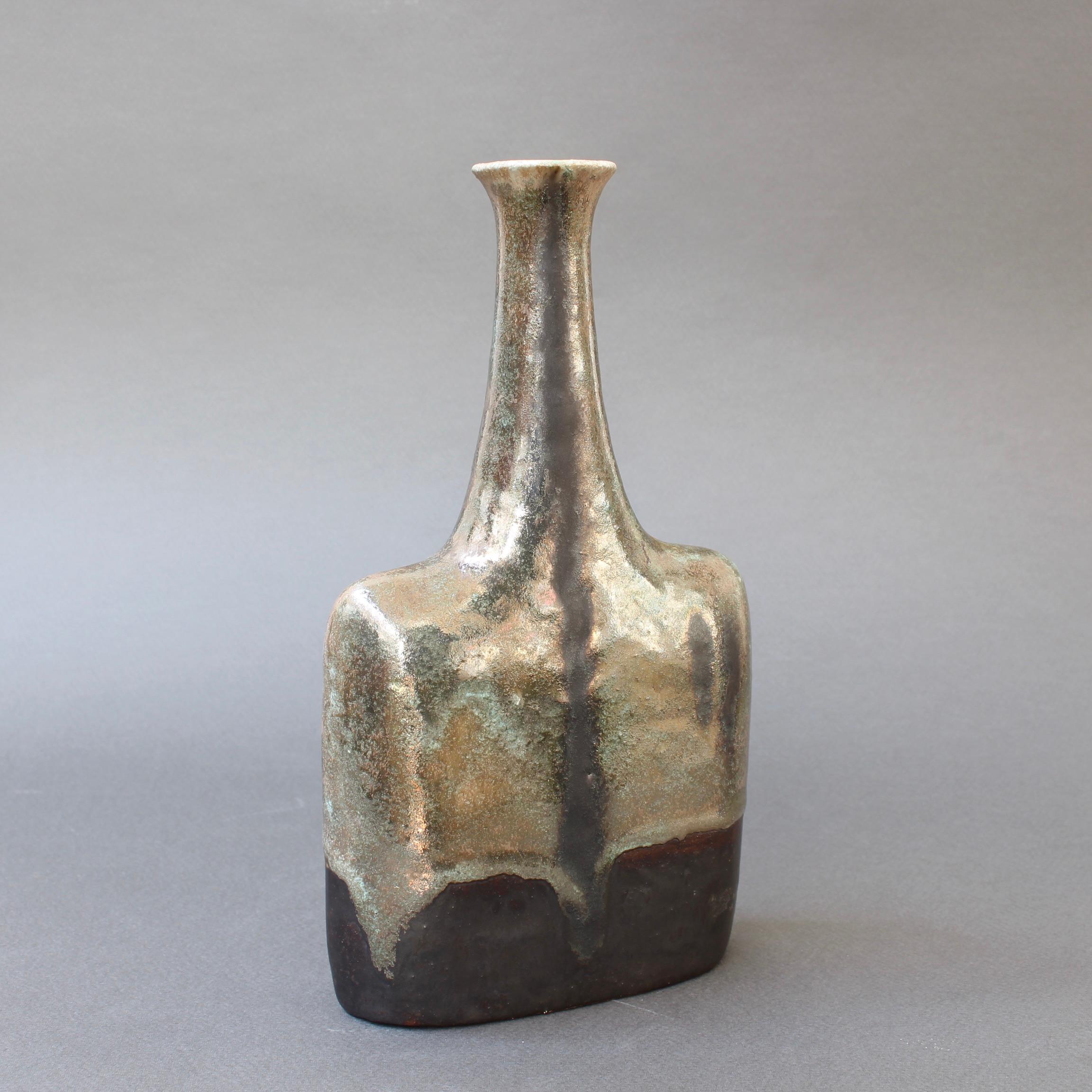 Ceramic vase / bottle with metallic-sheen glaze and verdigris drip motif by ceramicist Bruno Gambone, circa 1980s. This elegant, narrow-opening bottle-shaped vase is a work of art. There is a rectangular body with soft, curvy shoulders leading to a
