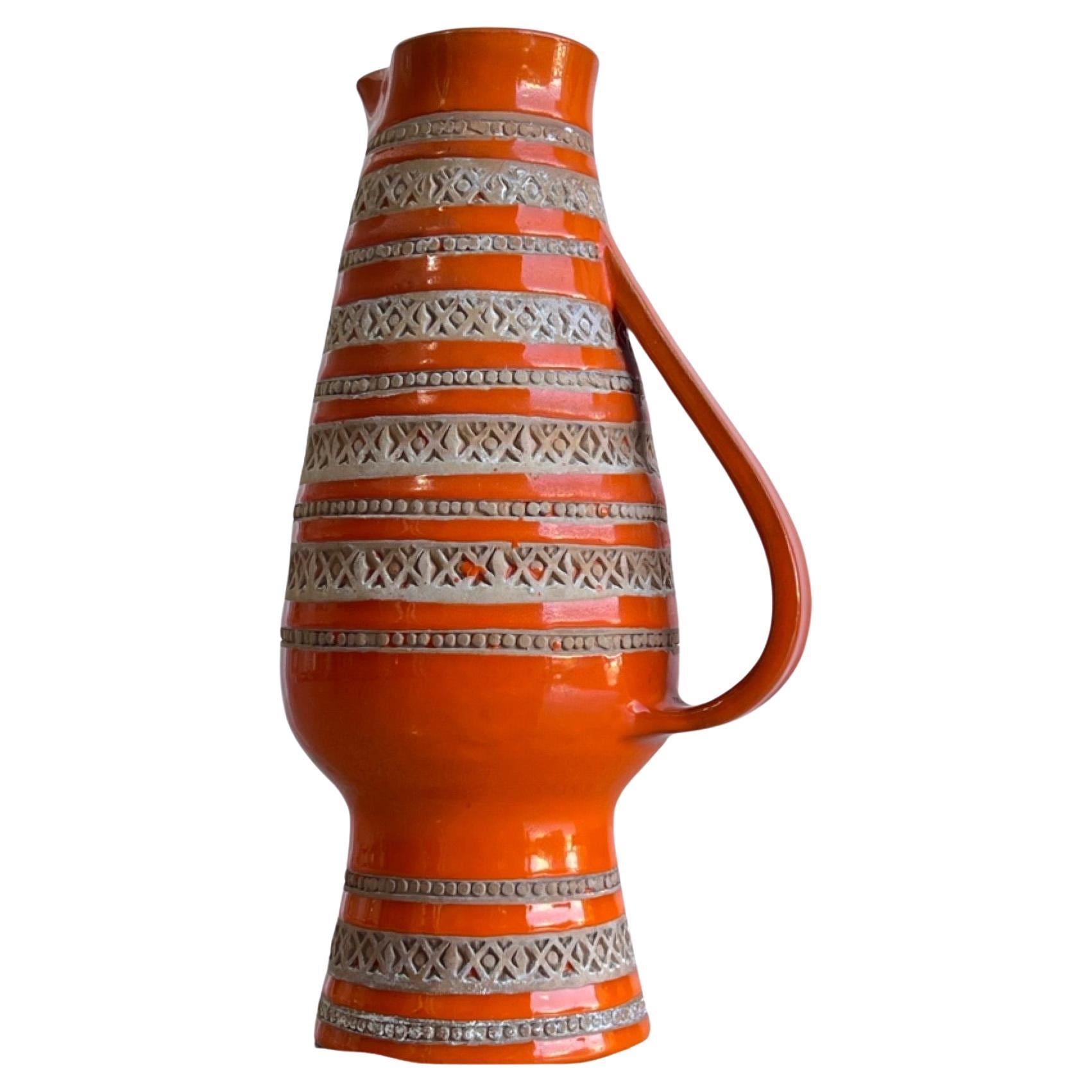 Italian orange ceramic water jar by Bitossi 1960s.
Glazed technique used by Aldo Londi, serial number and signature on the bottom of the jar.
  