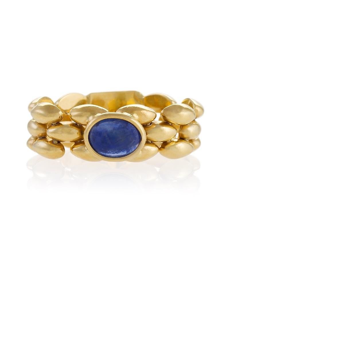A modern Italian 18 karat gold flexible chain link ring with sapphire. The entirely flexible band of the ring features a fetching woven pattern in high polish. The ring centers on a cabochon sapphire with an approximate weight of .90 carat. Circa