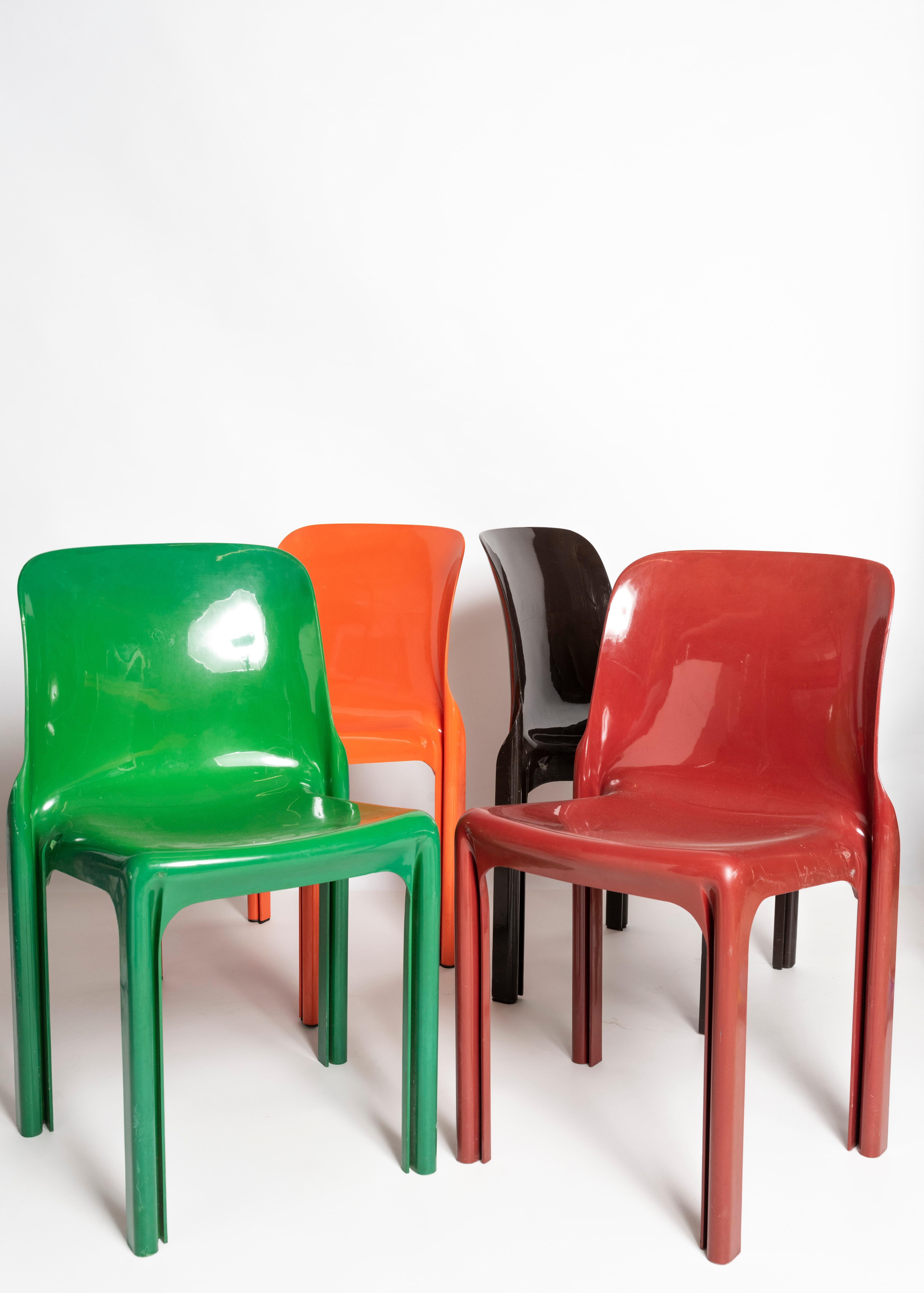 Stackable 'Selene' chairs designed by Vico Magistretti and manufactured by Atremide in Italy. These chairs are made of compression-moulded fibreglass and are available in orange, red, green, white and dark brown.