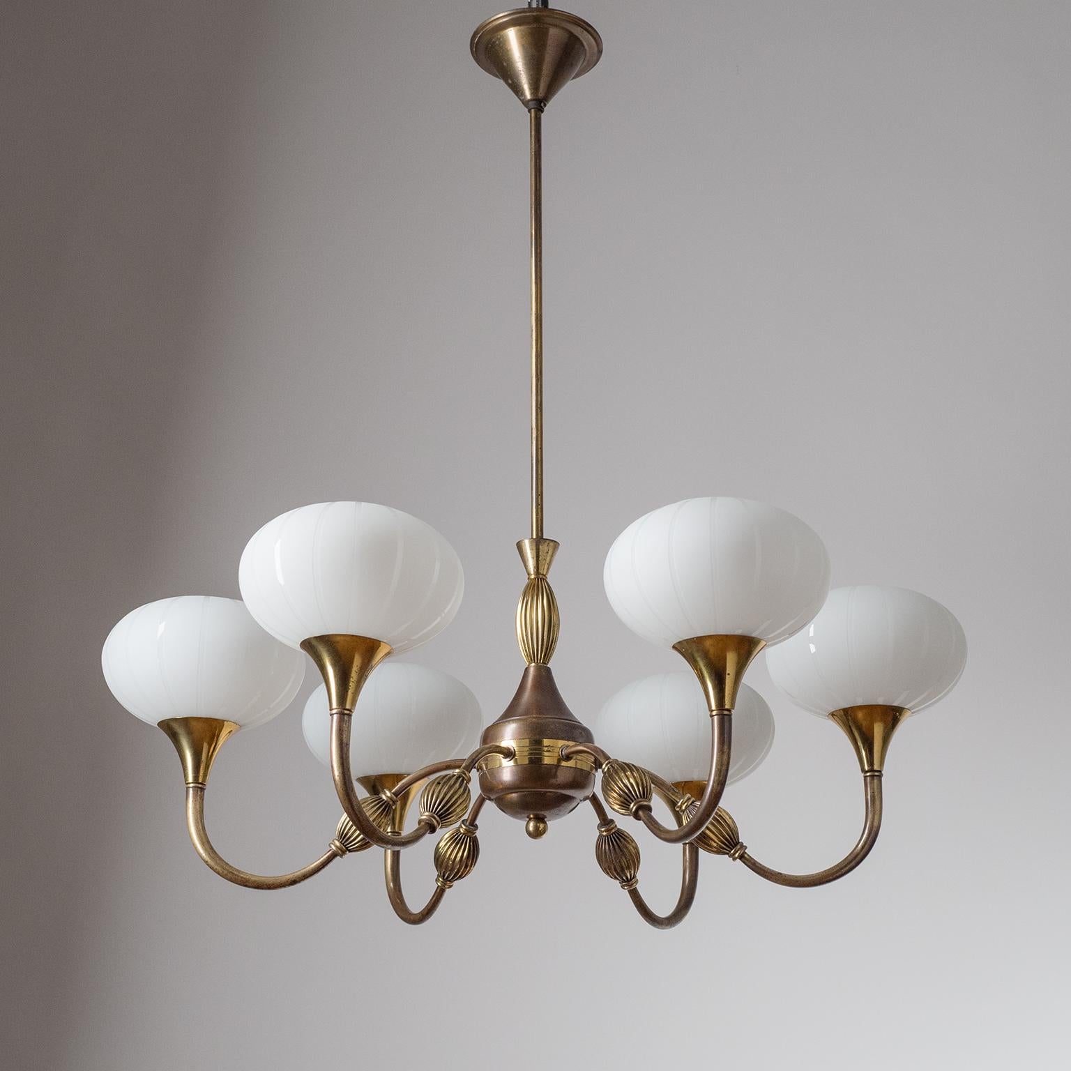 Italian six-arm brass chandelier from the 1940s. Rare 'pleated' brass decorations on arms and body and blown milk glass diffusers with satin-etched stripes. Original brass and ceramic E14 sockets with new wiring. Height without the stem is