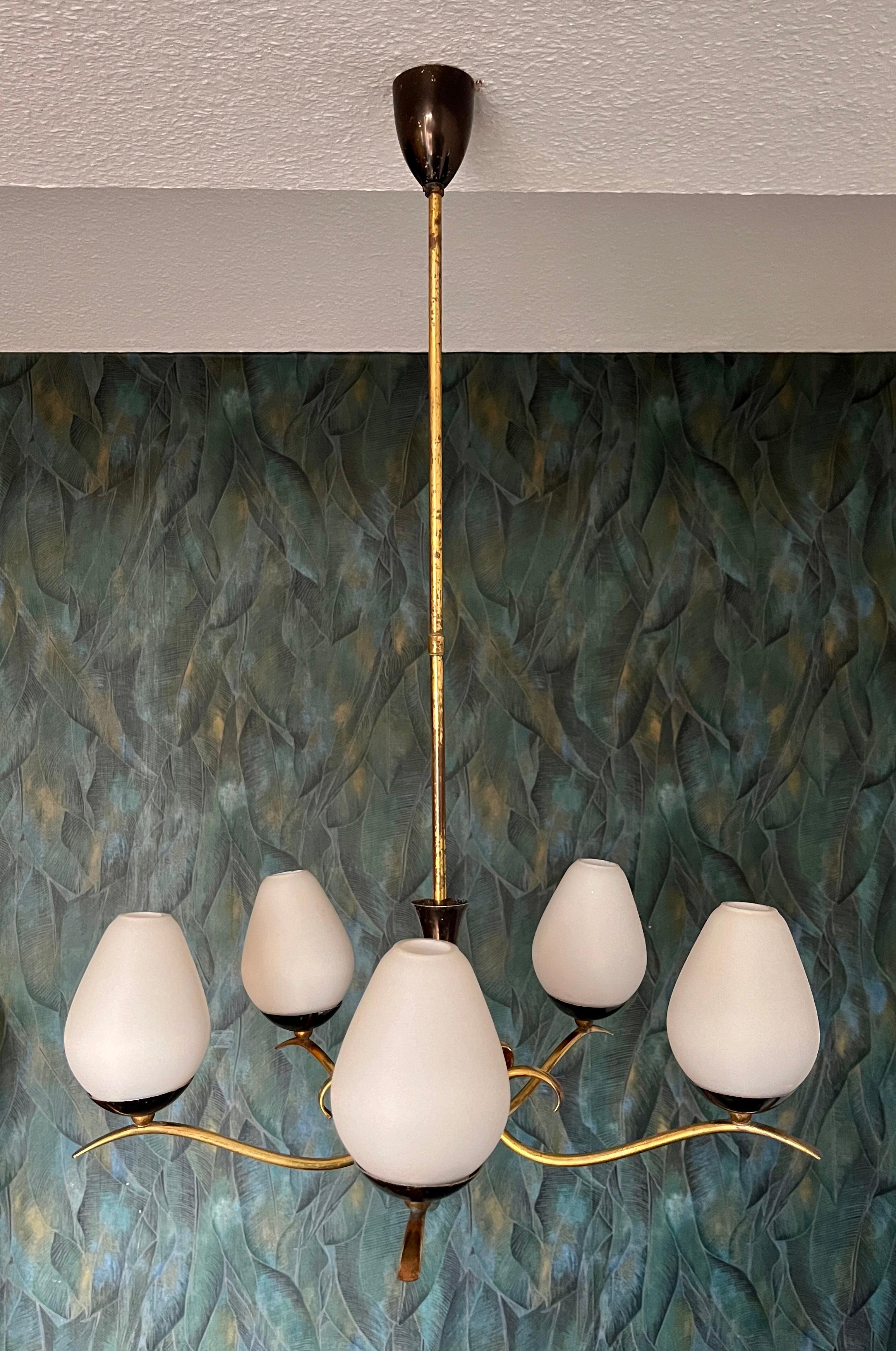 A delicate chandelier in the Stilnovo style. A genuine Italian chandelier from the mid-century.

This vintage item is fully functional and in good condition, but shows signs of wear consistent with age. It has a strong patina and slight scratches.