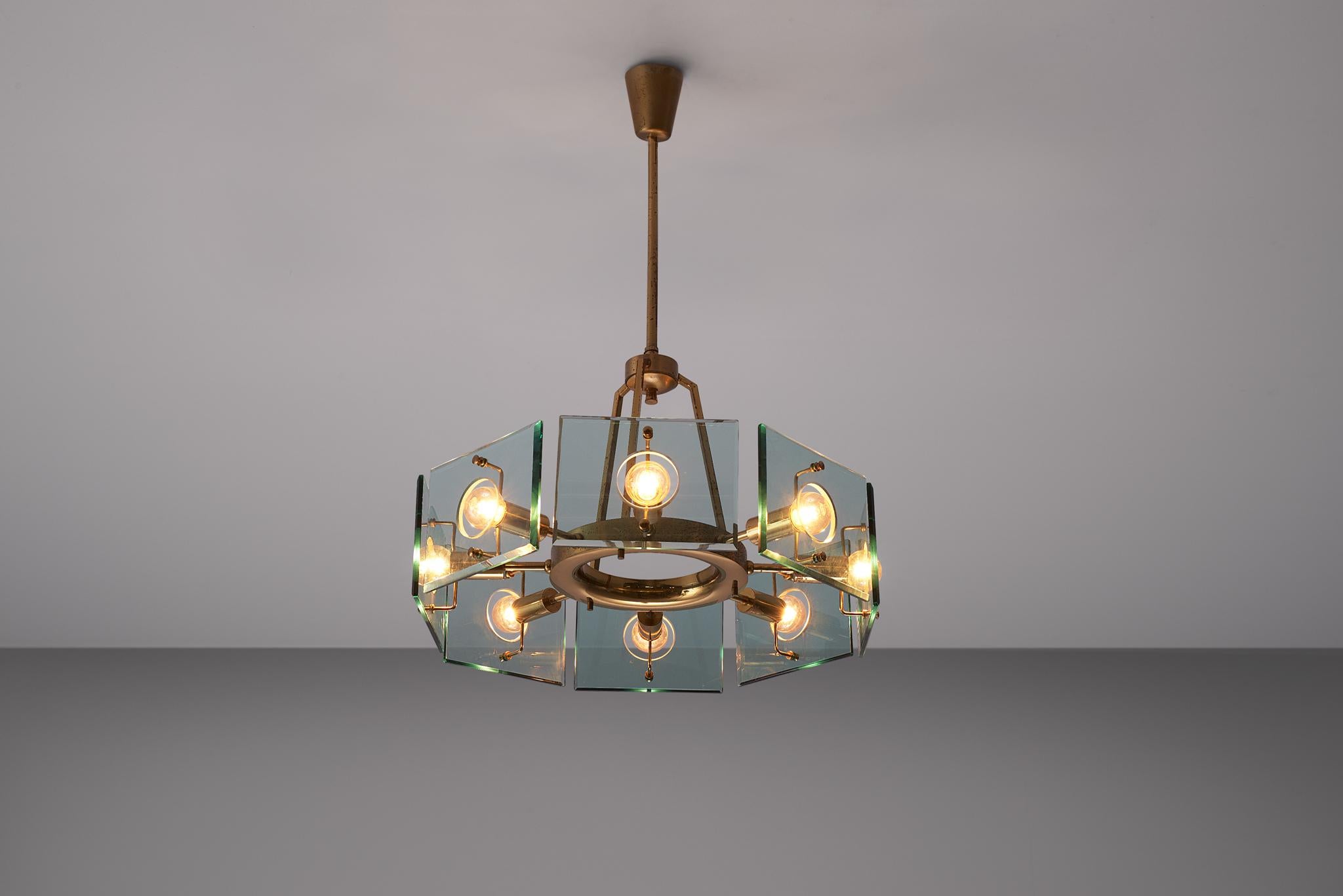 Gino Paroldo, chandelier, brass and glass, Italy, 1950s

Italian Postwar chandelier by the Italian designer Gino Paroldo. The fixture is made of one brass stem, which run into a round shaped shade with 8 light points that are covered with slightly