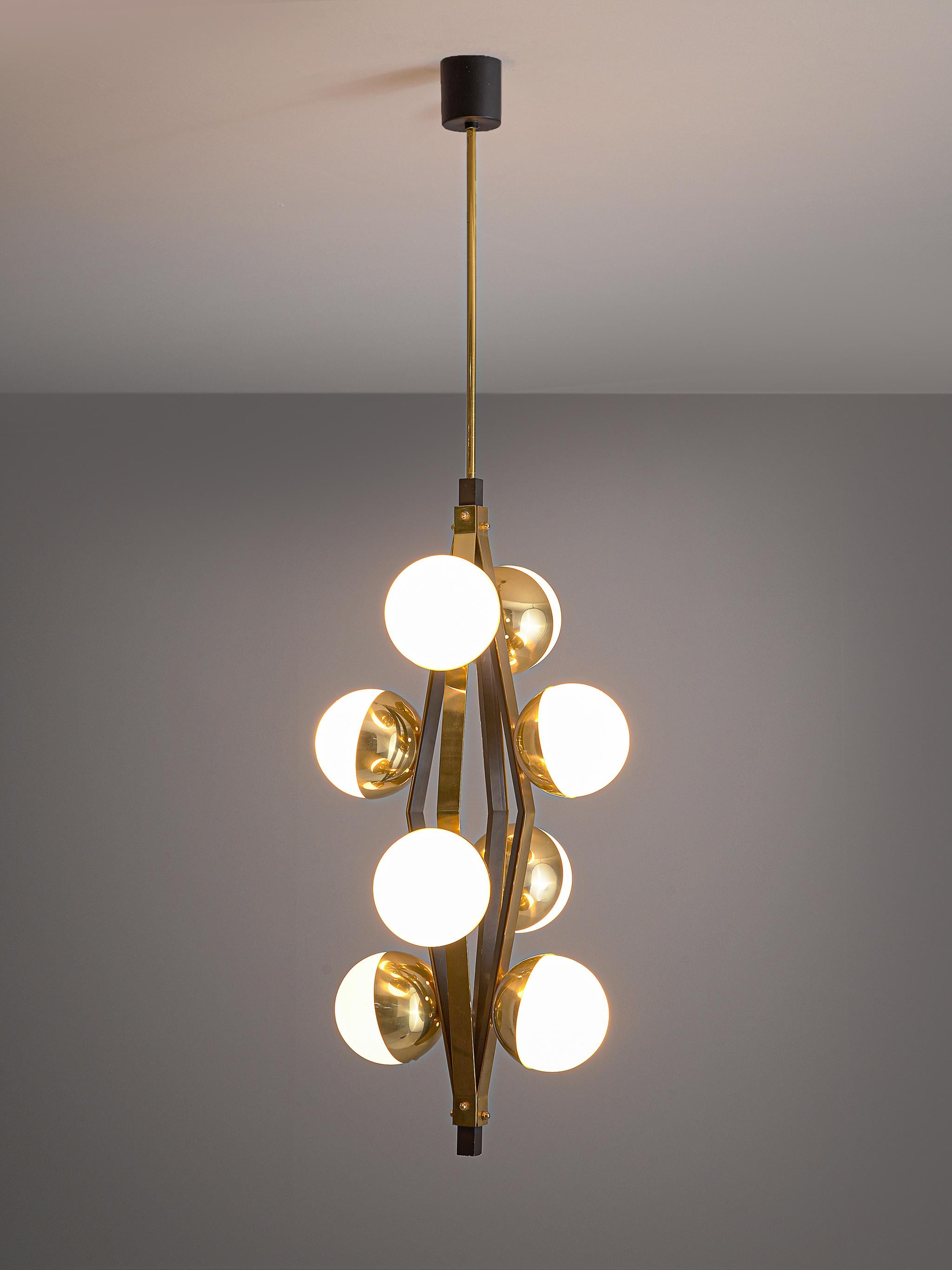 Chandelier, brass and opaline glass, Italy, 1950s.

Well designed chandelier from Italy, attributed to Stilnovo. The bulbs are held in place by brass bowls that are attached to a brass stroke. The pendant light consists of 4 strokes that are