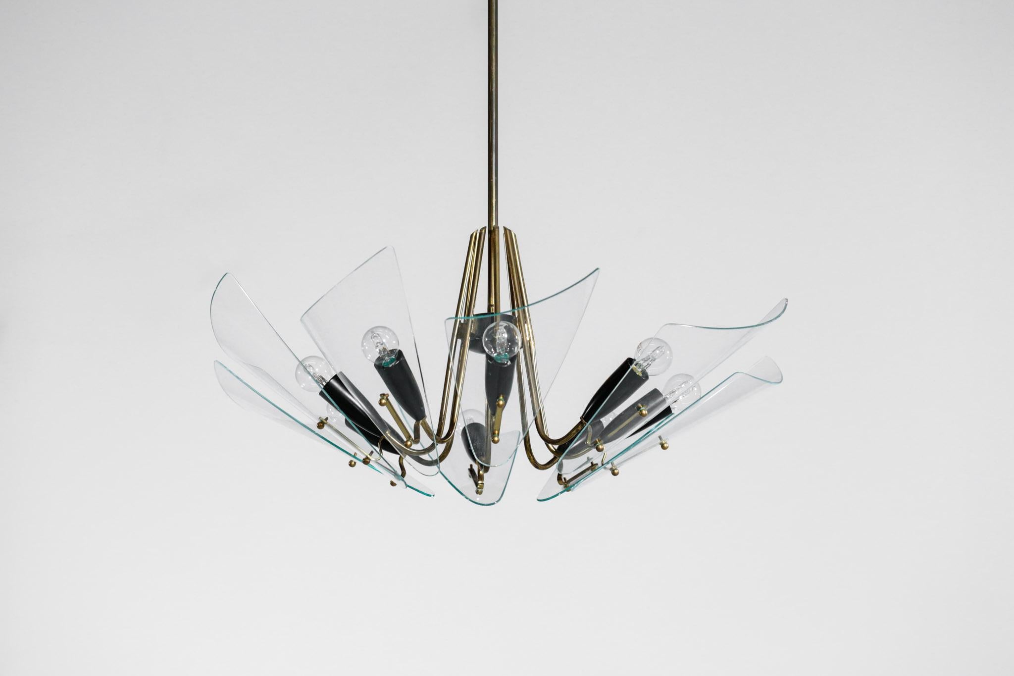 Italian chandelier from 1970s. Structure in brass with black metal socket and glass shade. Bulb E14.