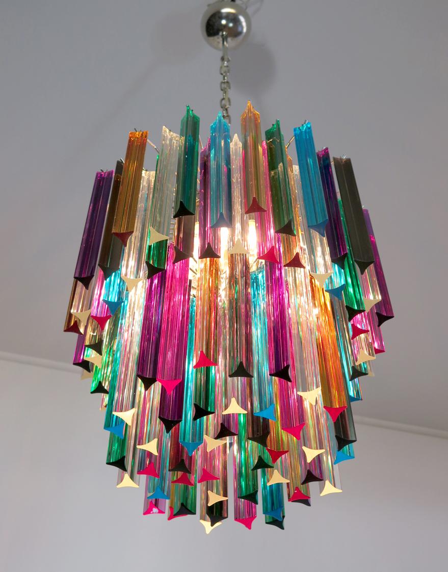 Fantastic chandelier made by 107 Murano crystal multicolored prism in a nickel metal frame. The glasses are transparent, blue, smoky, purple, green, yellow and pink.
Dimensions: 55.10 inches height (140 cm) with chain, 29.50 inches height (75 cm)