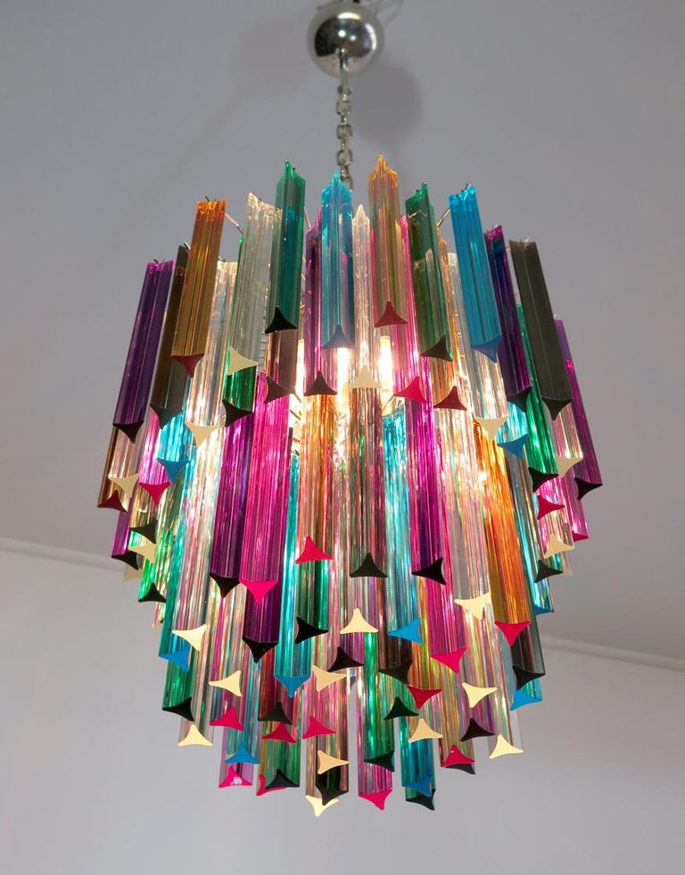 Fantastic chandelier made by 107 Murano crystal multicolored prism in a nickel metal frame. The glasses are transparent, blue, smoky, purple, green, yellow and pink.
Dimensions: 55.10 inches height (140 cm) with chain, 29.50 inches height (75 cm)