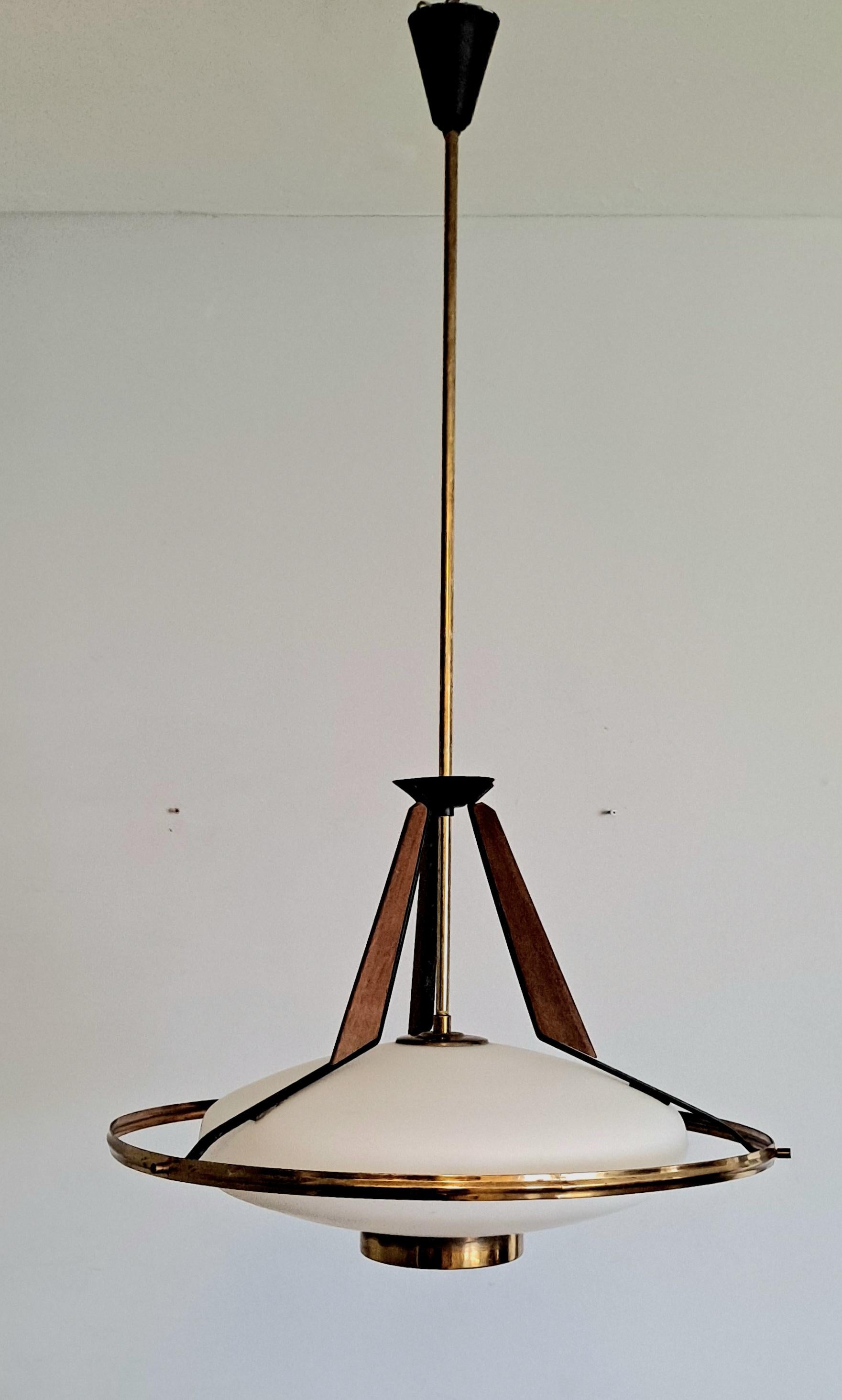 Elaborated chandelier  opaline glass shade and great teak and brass details. It was made in the 50s by Stilux Milano, Italy. Great original condition.
the chandelier can be shipped with the upper part dismantled which will lover the UPS  standard
