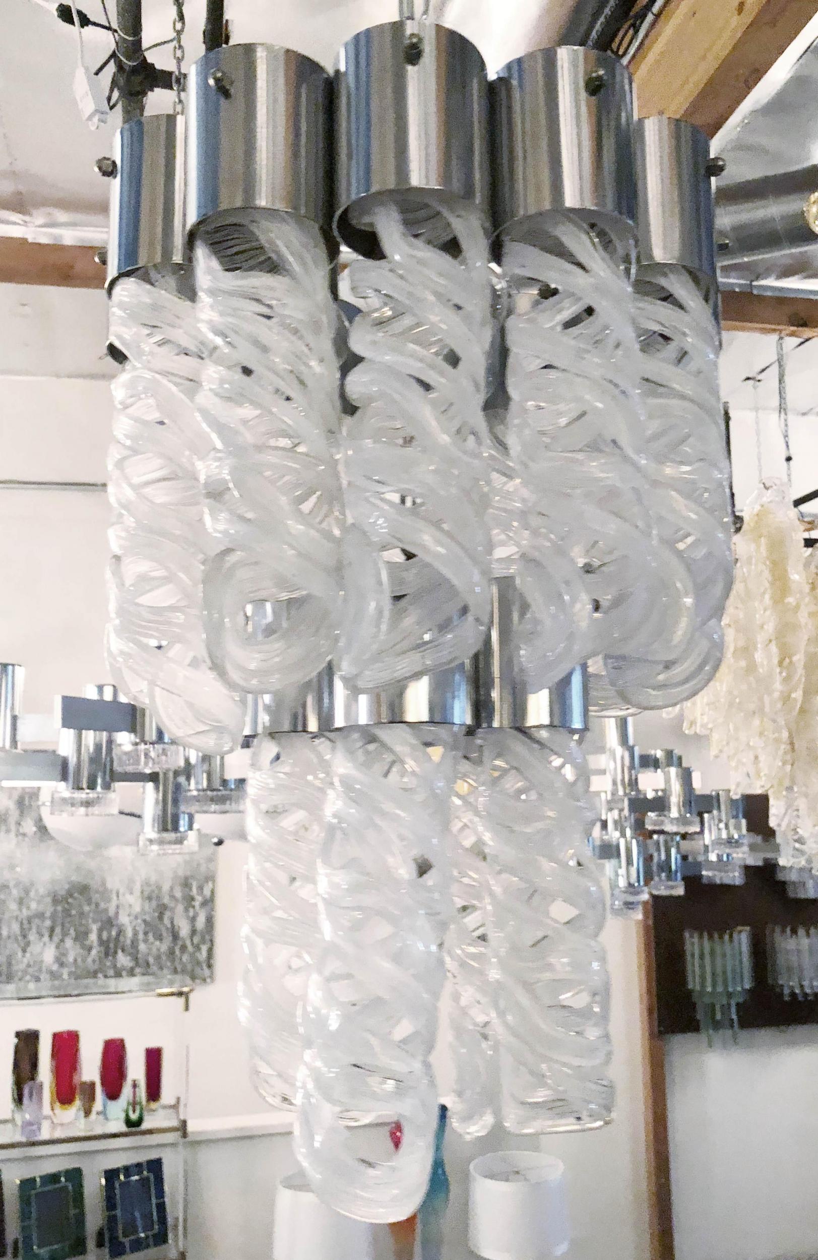 Vintage Italian chandelier w/ milky white Murano glasses handmade into spiral shape on chrome frame / In the style of Mazzega / circa 1970’s.