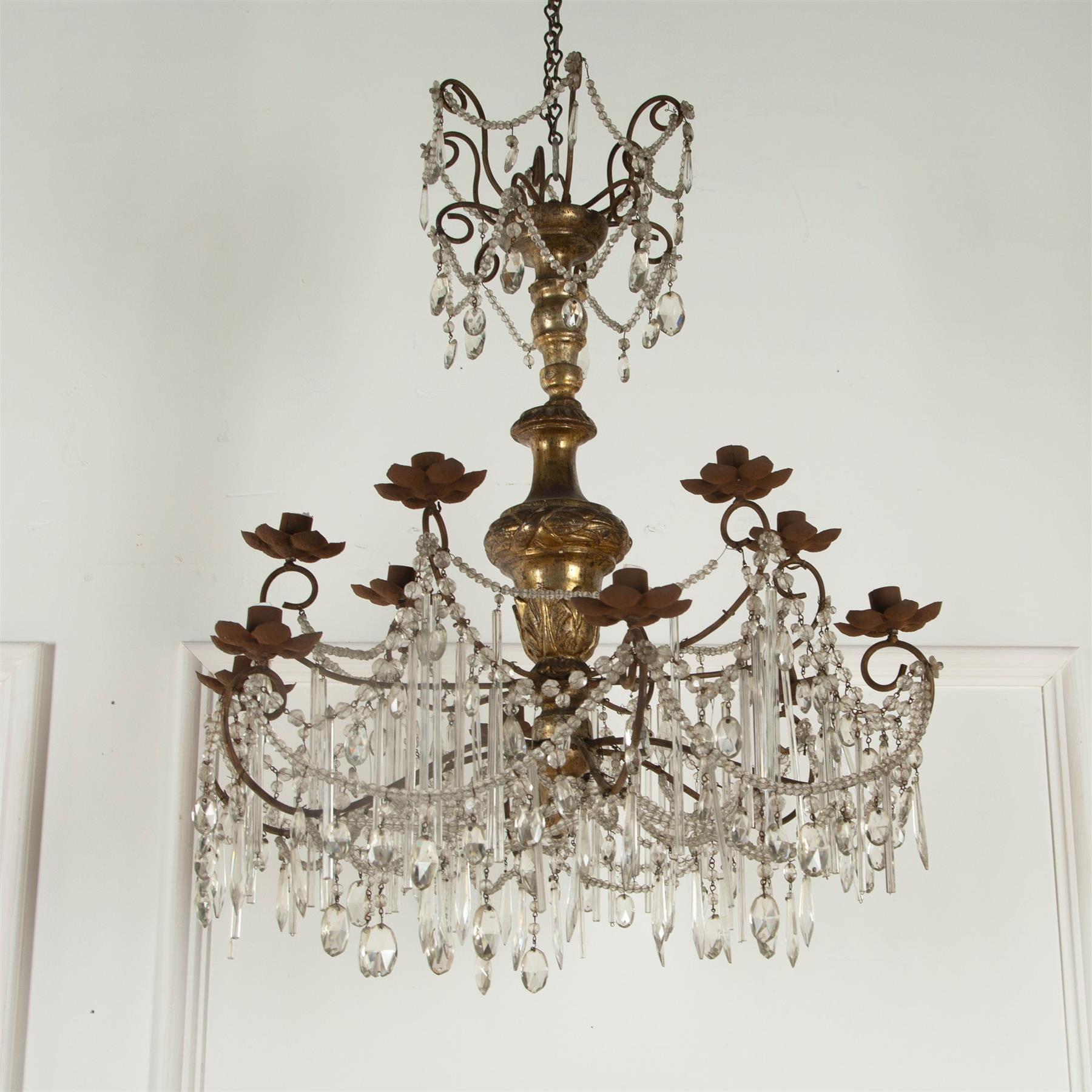 A 19th century Italian chandelier of the carved and silvered center stem, redressed with glass, mid-20th century. Currently unwired for use with candles.