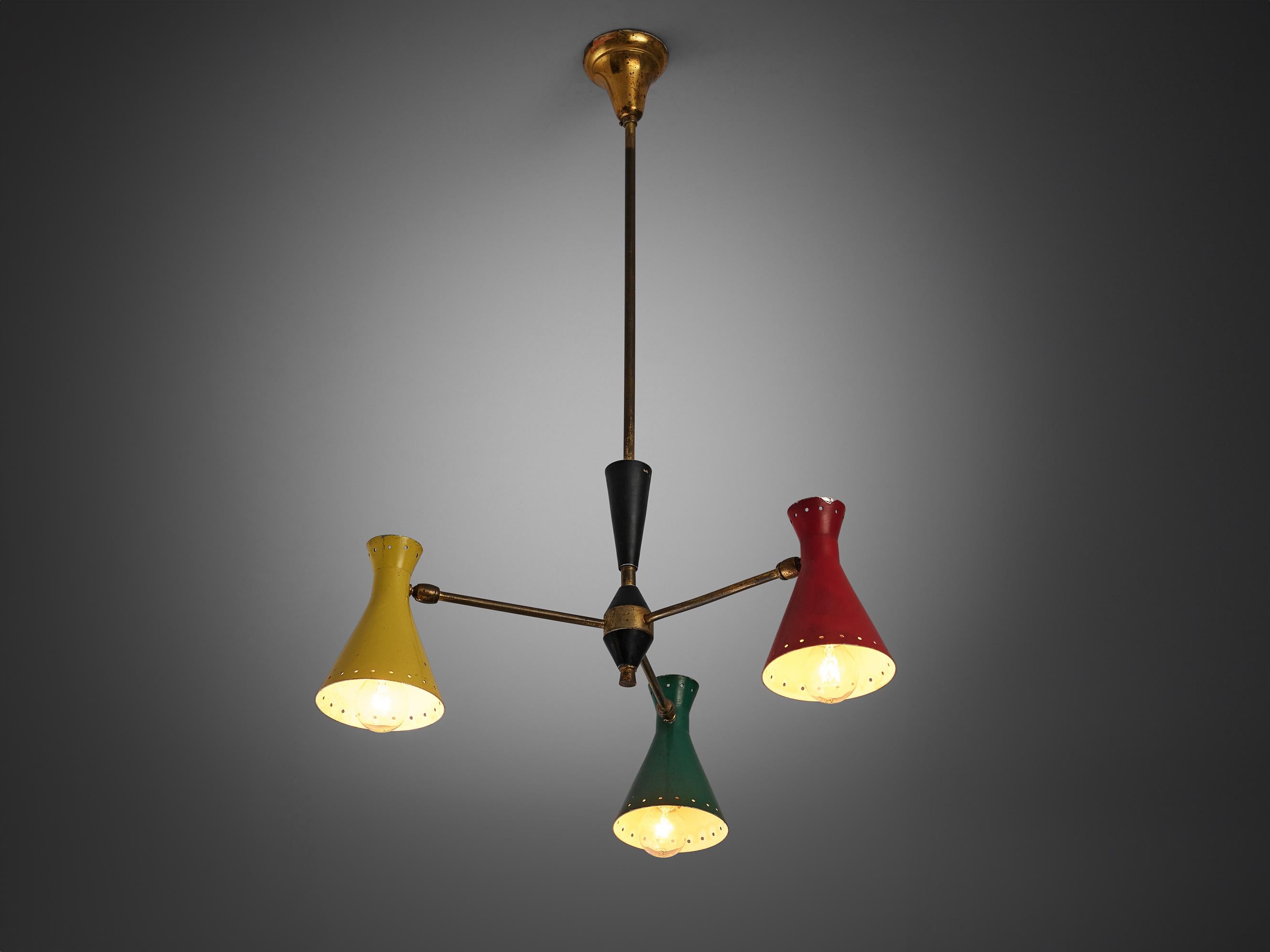 Chandelier, metal, brass, Italy, 1950s

Beautiful Italian chandelier with colourful cone shaped shades. A tripod frame in brass holds the green, red, and yellow shades with perforations along the sides that can be adjusted in their angle. The lamp