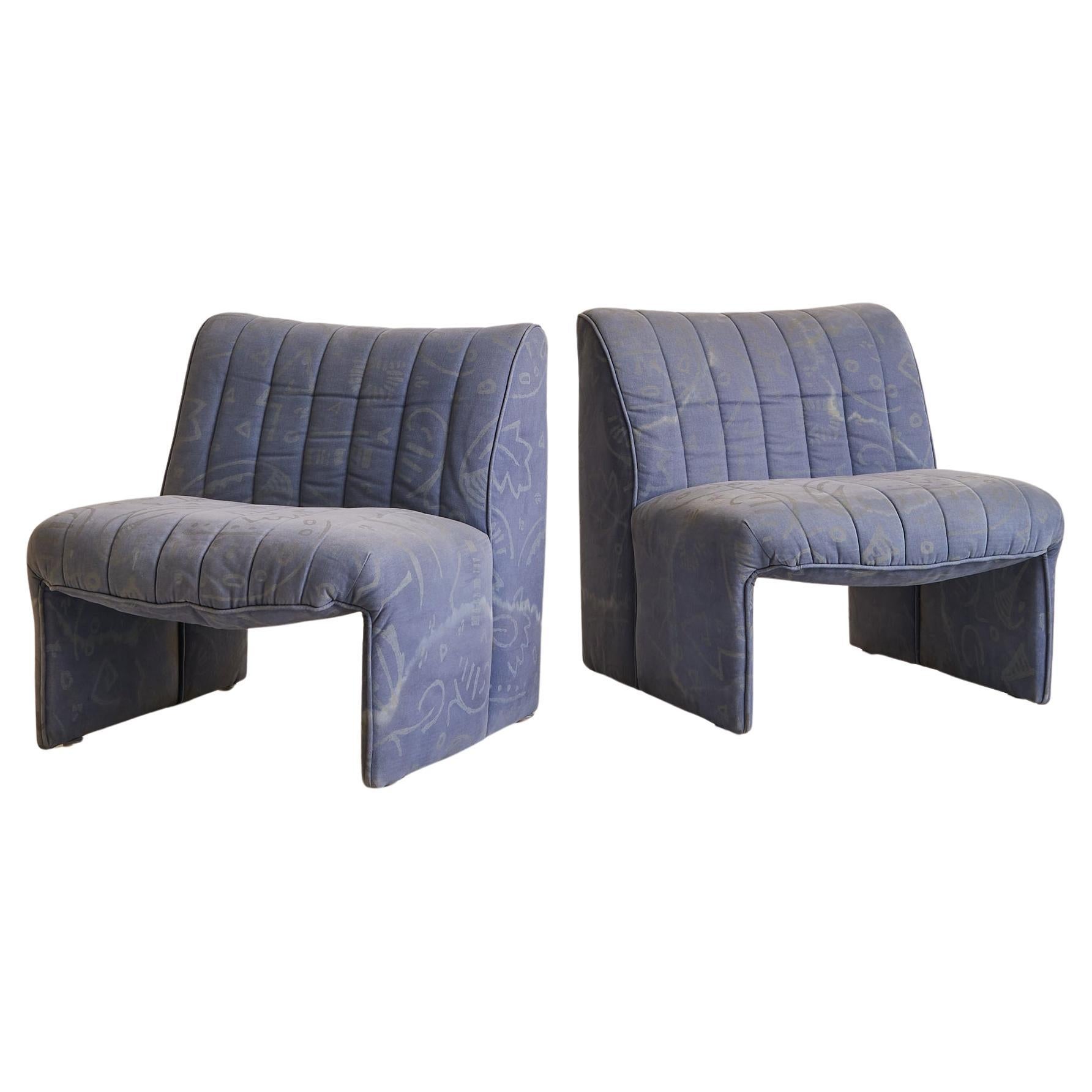 Sold and priced individually.

A 1970s Italian lounge chair, defined by its fluid silhouette and low, grounding proportions. The design features a wide seat and subtly flared back, upholstered in channel-stitched fabric over a deep, architectural