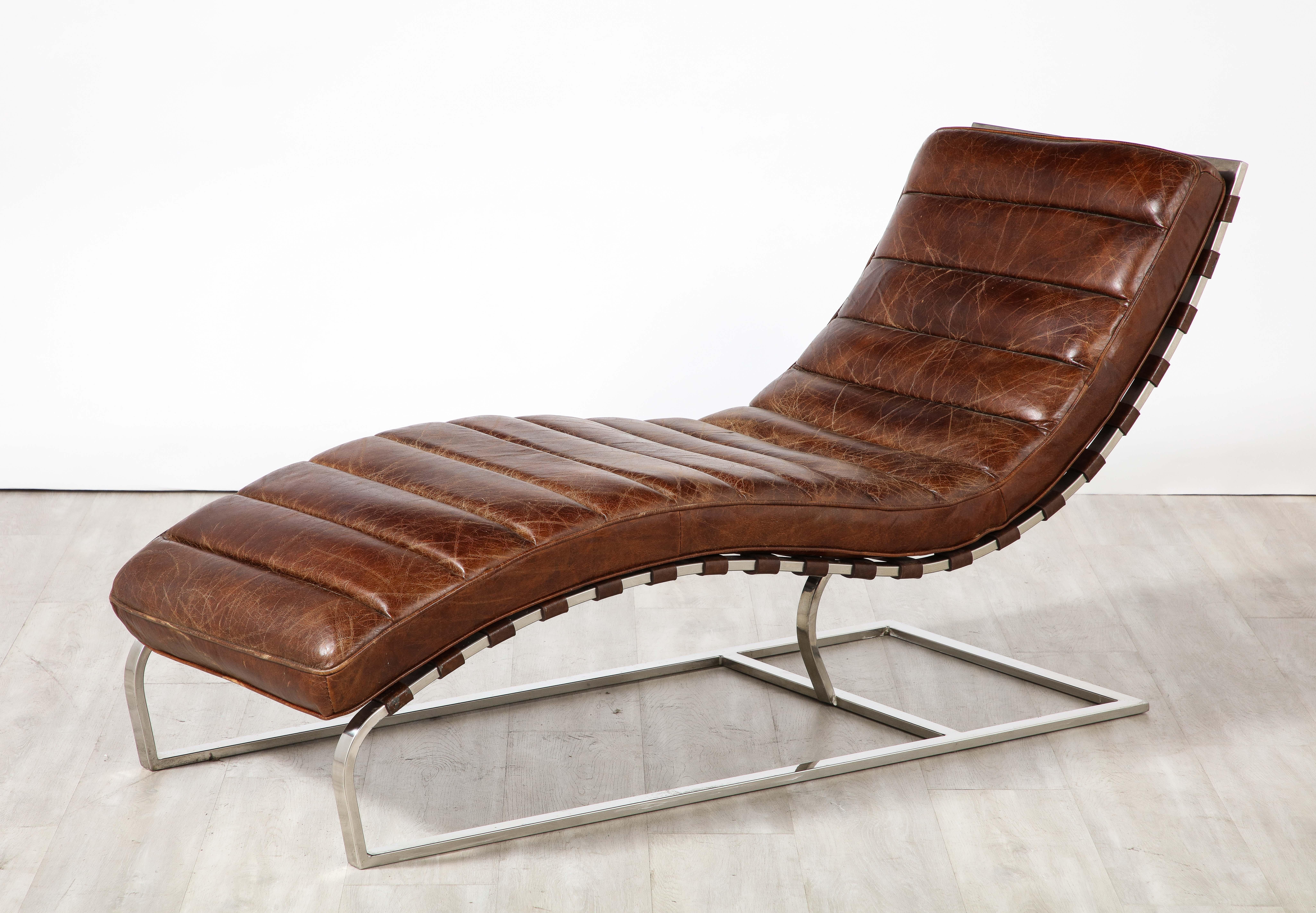 A handsome chocolate brown channeled Italian leather chaise longue from the 1970's. The sloping contoured wavy curved frame sits in harmony with the angular chrome support. The warm and rich chocolate brown leather contrasts beautifully with the