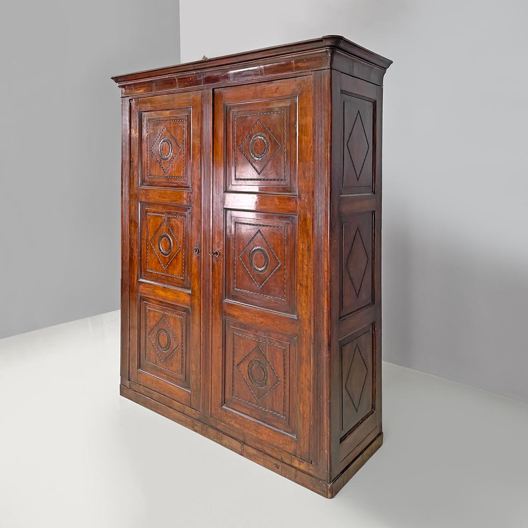 Italian Charles X style two-door wooden wardrobe with decorations, early 1800s
Two-door wardrobe entirely made of wood. On the front and sides there are engraved geometric decorations. Inside there are two compartments, in the upper part there are