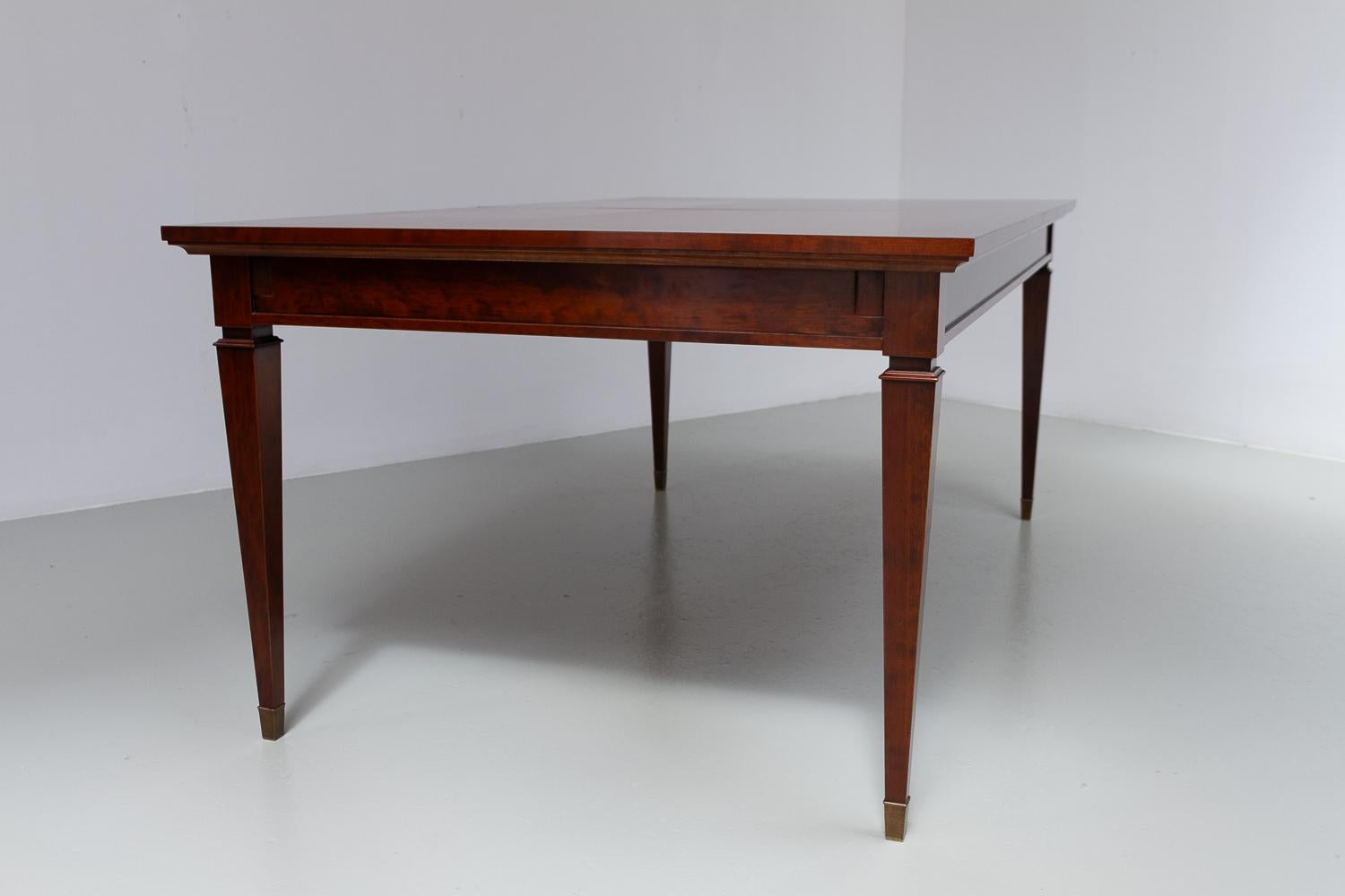 Italian Cherry Extendable Dining Table by Annibale Colombo, late 20th Century.

High quality dining table in beautiful warm cherry wood manufactured in Italy by Annibale Colombo in the late 20th century. Makers mark on metal plaquette on extension