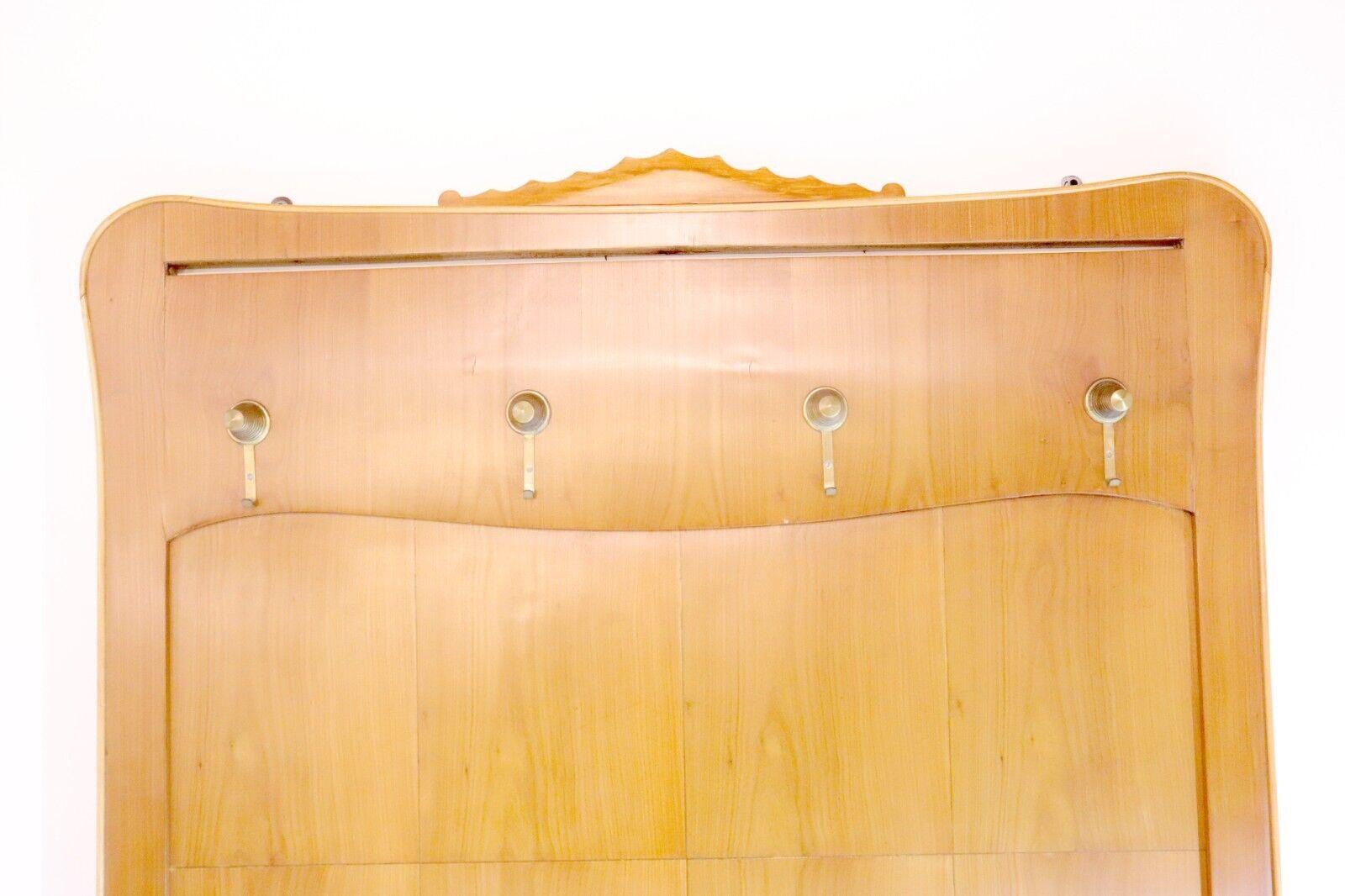 A beautiful 1950's Italian cherry wood wall panel / coat rack with brass hooks.