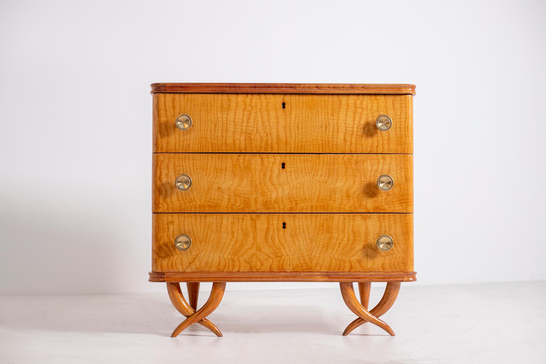 Elegant and Classic Italian chest of drawers by Paolo Buffa, circa 1950. The chest of drawers is in well made walnut wood. The chest of drawers has 3 drawers that can be pulled out through two brass knobs on each side. In the middle we find the