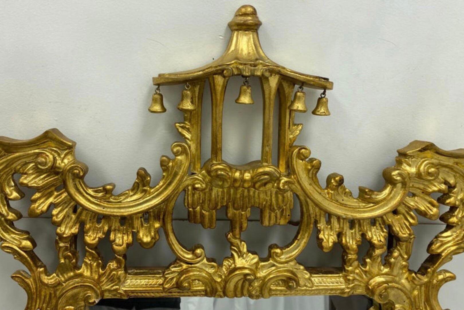 This is a pair of Chinese Chippendale style carved giltwood mirrors by Decorative Crafts in very good condition. They are marked and date to the 1970s.