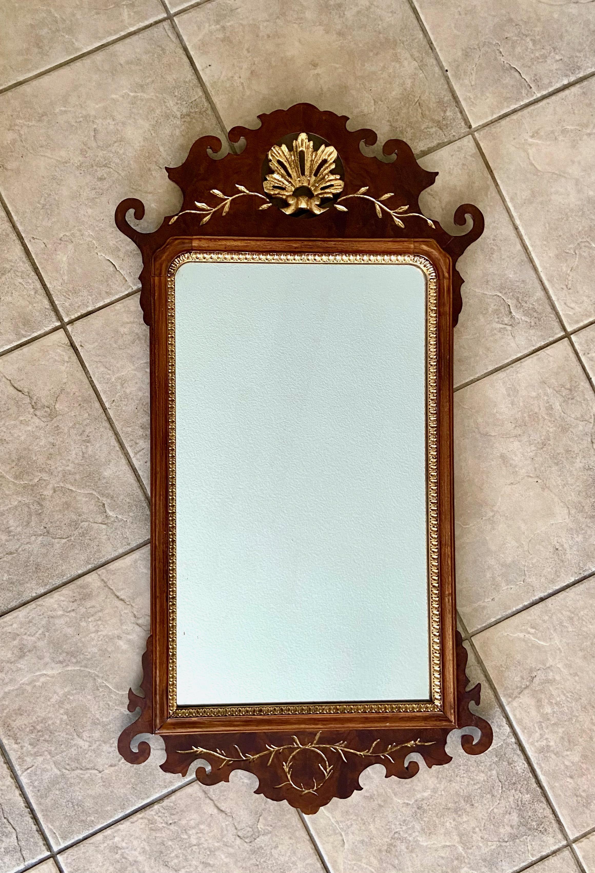 Chippendale style carved walnut wood with gilt highlighting wall mirror. Label on back 
