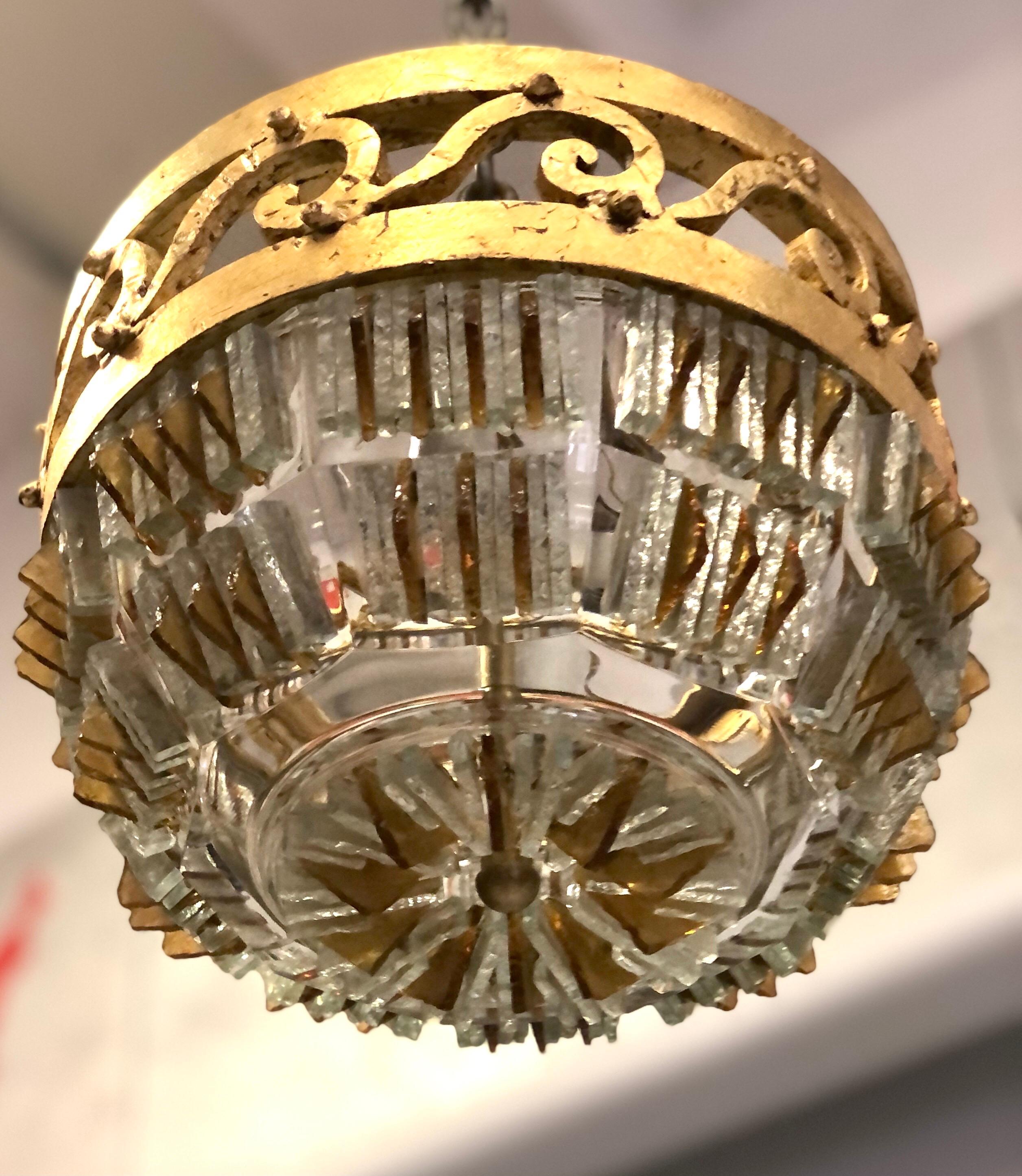 2,rare and exceptional, Italian Mid-Century Modern neoclassical, hand chiseled clear and amber murano glass flush mounts or pendants attributed to Max Ingrand and Fontana Arte. The glass is fitted to an original hand hammered and gilt wrought iron