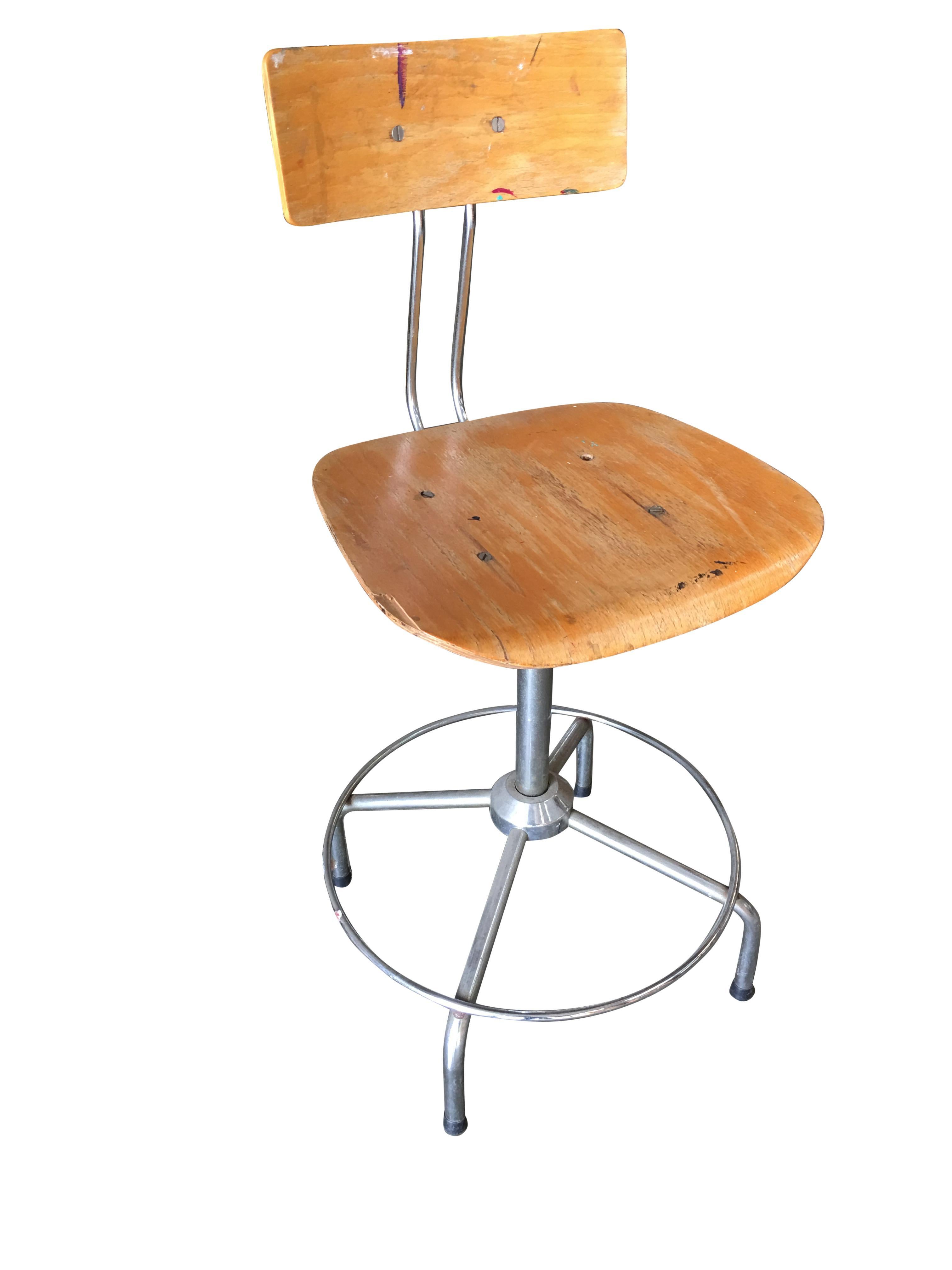 Artist's drafting table work stool featuring a chromed steel base and formed birch plywood seat made by Bieffee in Italy. Circa 1970. This chair has some wear from use. The swivel functions perfectly.

Dimensions:
36