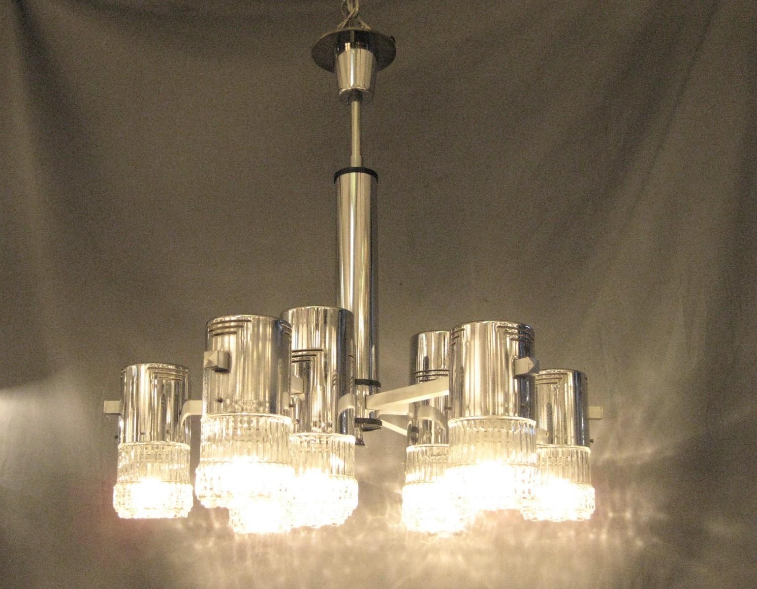 Italian Modernist chandelier of elemental architectural post and beam design. 
Chromium plated over bronze with crystalline pattern on glass and linear open work design on cylinders.
Attributed to Sciolari
Some light pitting to metalwork.
1960s,