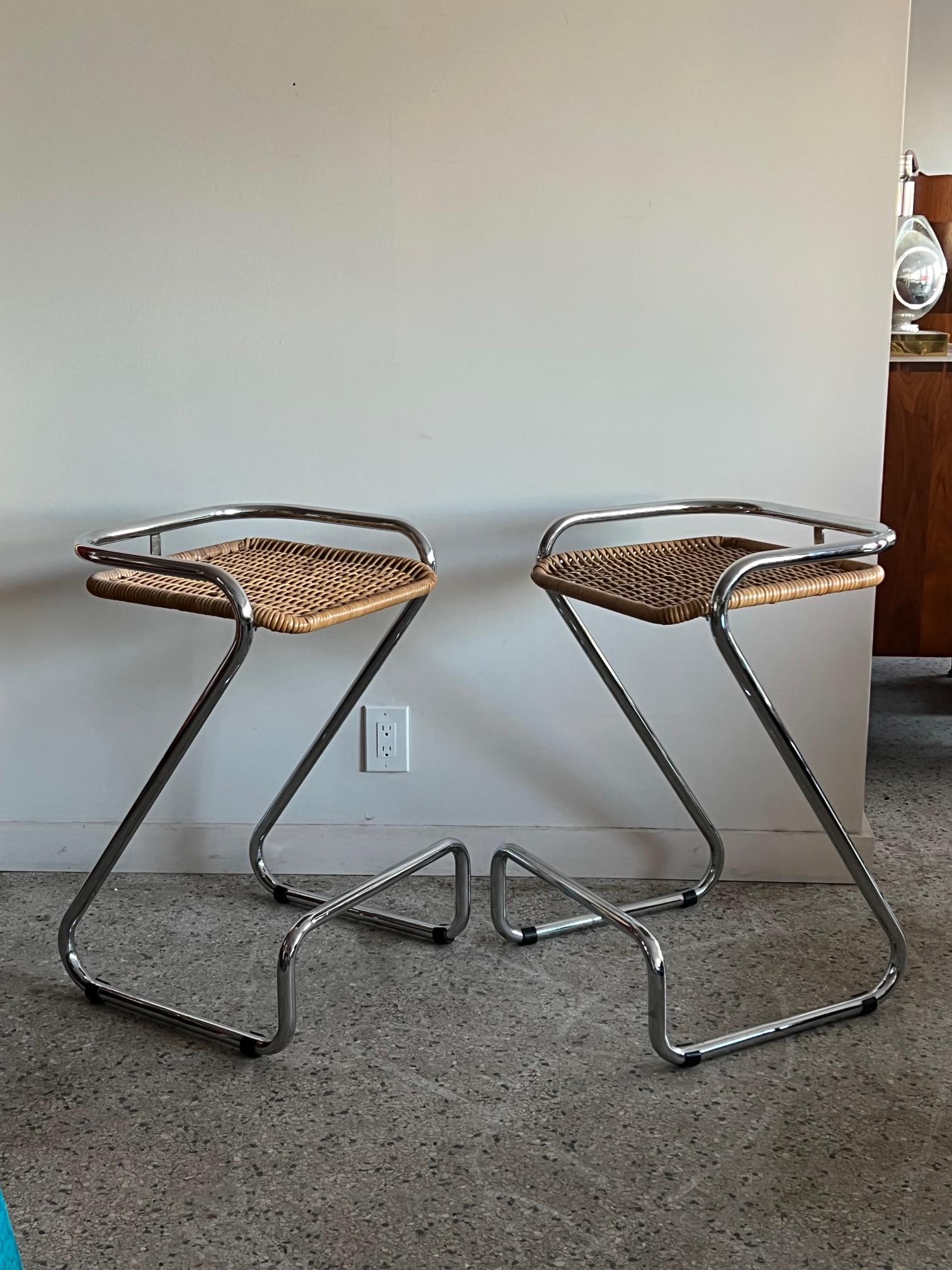 A pair of chrome steel and wicker bar stools attributed to Mariani, made in Italy ca' 1970's. Clever design-stylish and practical and perfect for a small bar.