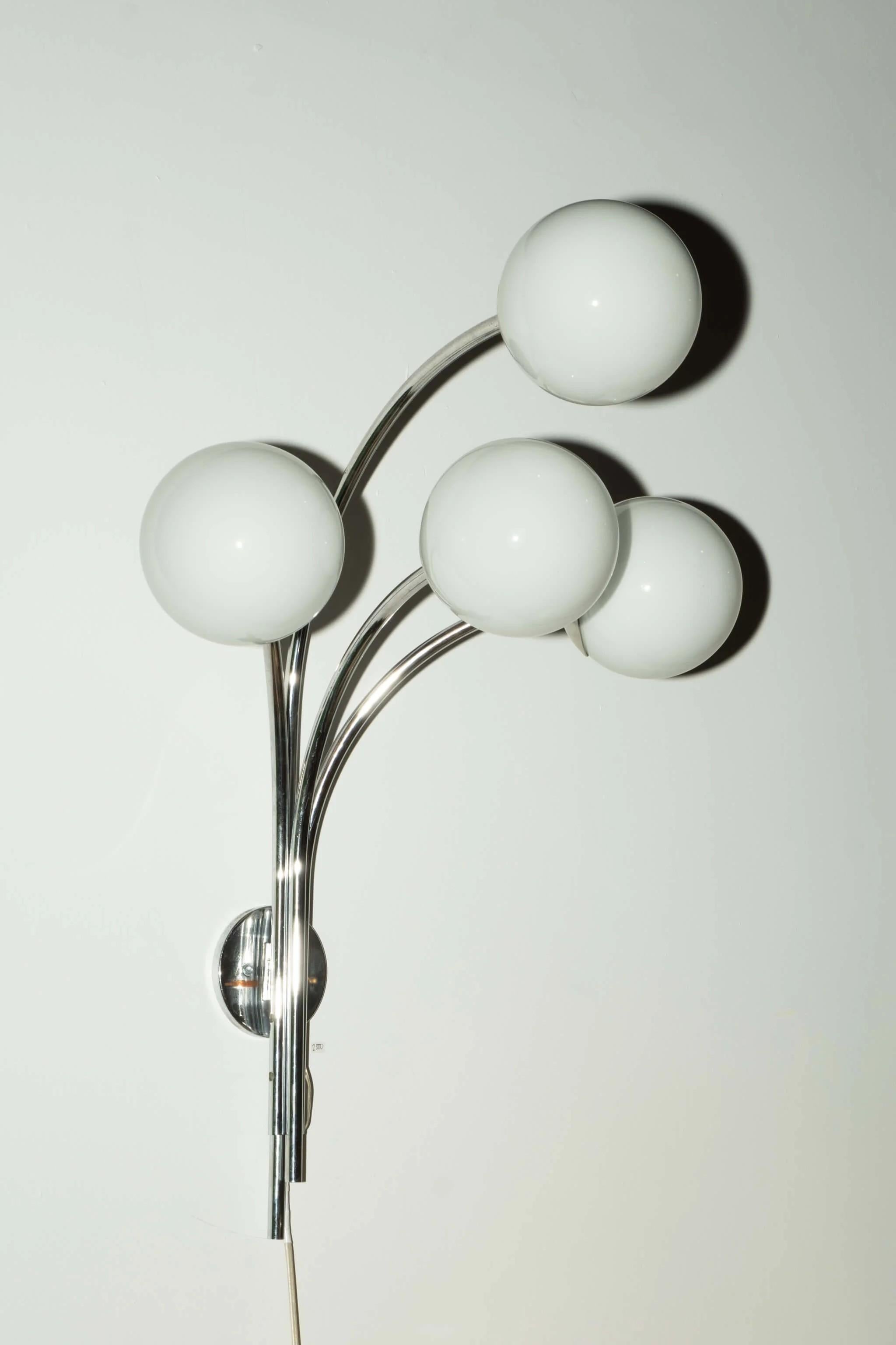 A bouquet of chrome with 4 glass 'flowers' projects spectacularly from the wall on this 1960s wonder from Arteluce - one of the companies at the heart of the creative explosion in postwar Italian design.