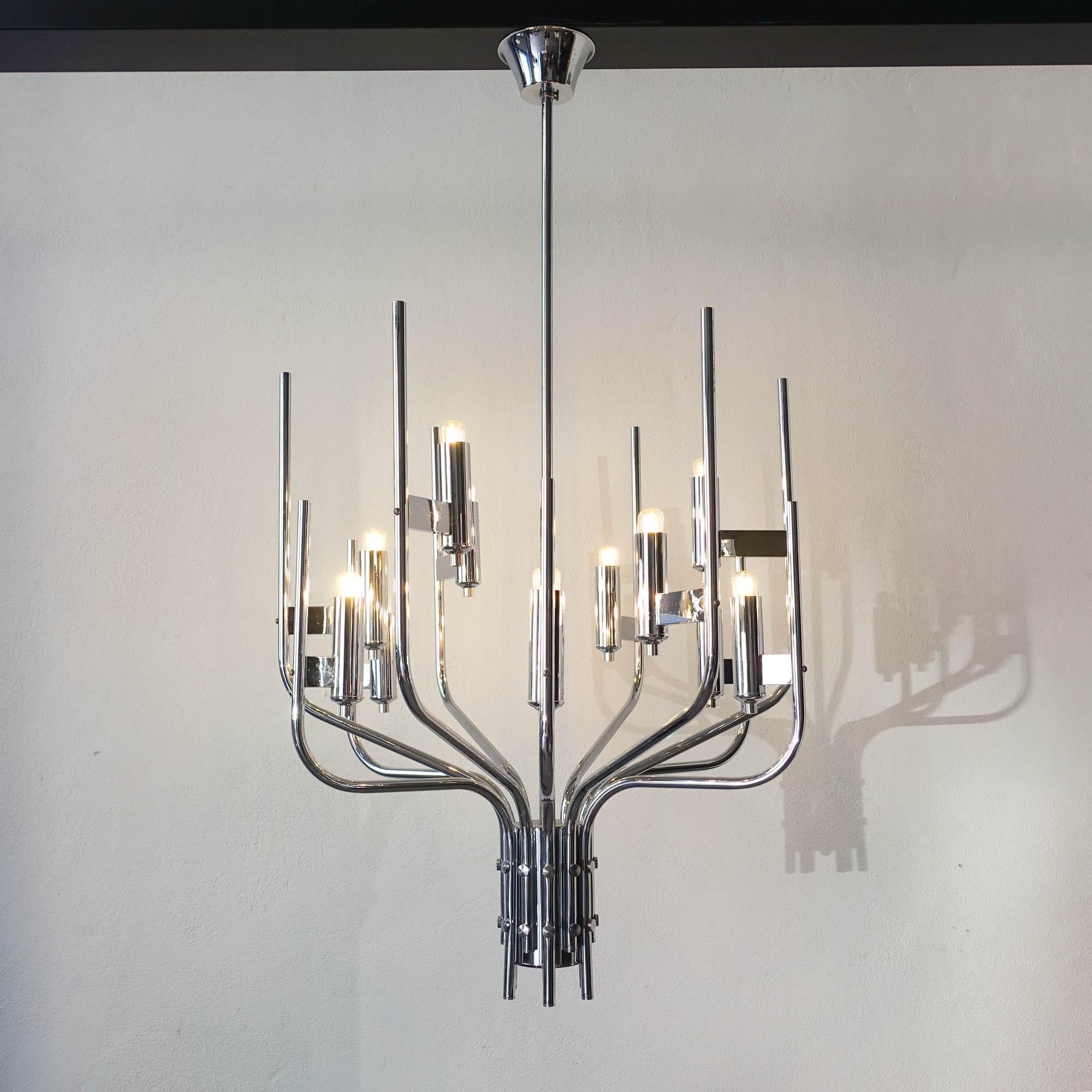 This piece was designed by Gaetano Sciolari, in Italy, during the 1970's. It has a minimalist design, inspired in the old chandeliers. With a chromed frame, the fixture requires 12 E14 bulbs. The electric system can work in two distinct phases.