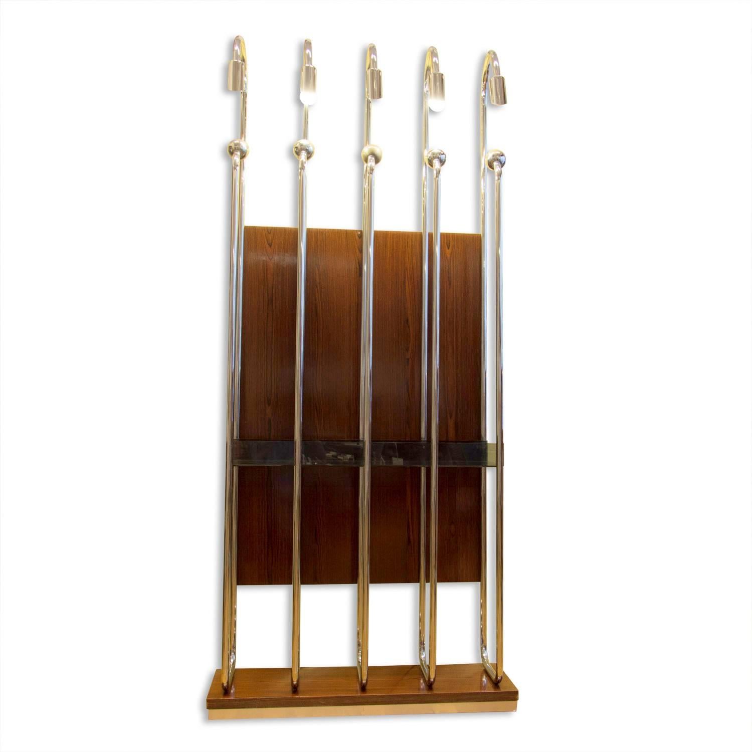 This Italian entrance or hall coat rack was produced in Italy in the 1970s. It features five chrome-plated hangers which are illuminated by five lights from the top. Also, it features wood veneered parts and one shelf in the middle of the rack.