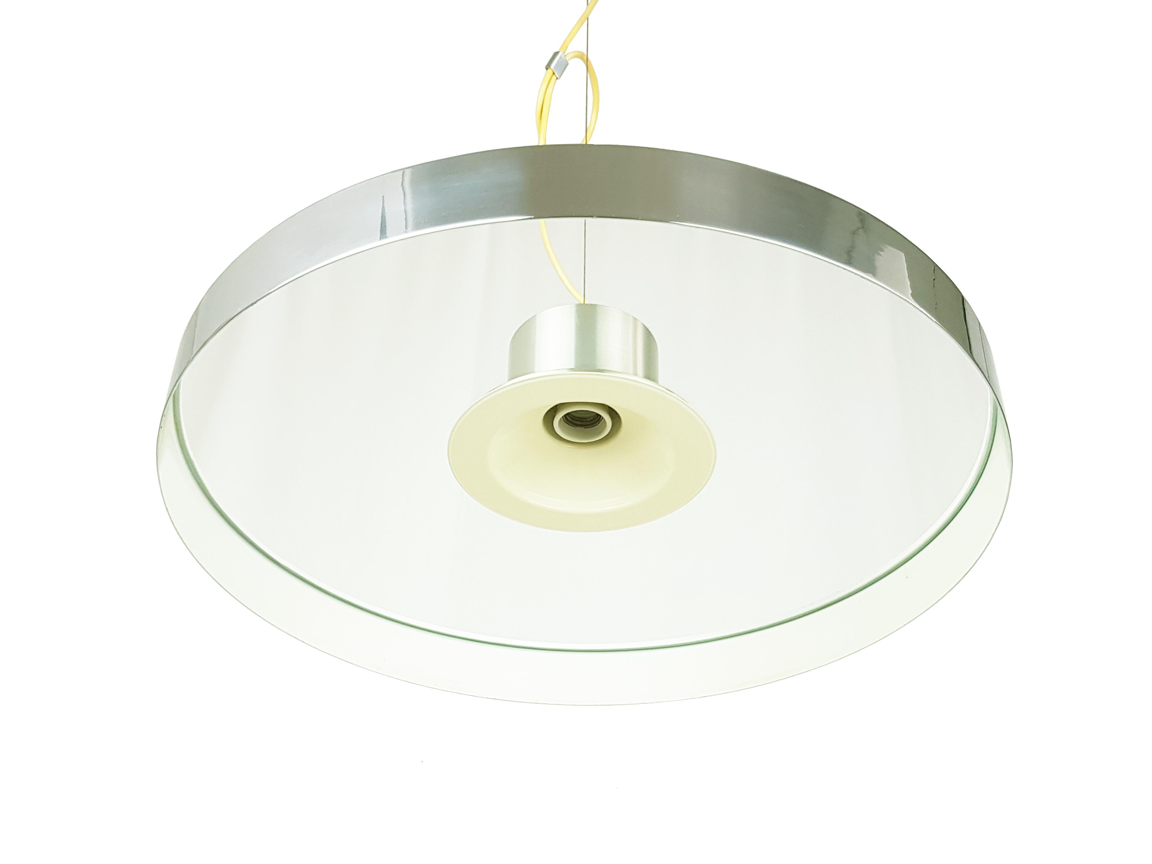 Fine and elegant pendant lamp from the 70s. This lamp was produced in Italy and it is made from aluminum (Canopy and upper body), chrome plated & white painted metal (ring shade) and round glass (shade). The thick metal circle is simply leaning