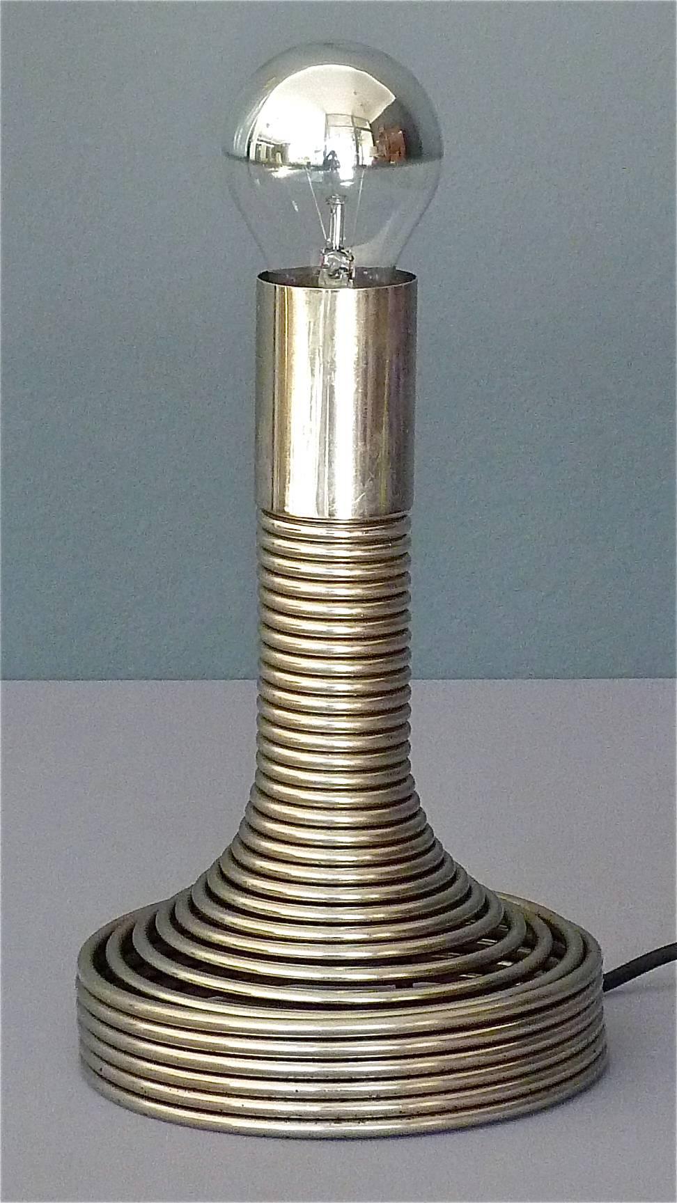 Fabulous “Spirale” table lamp designed by Angelo Mangiarotti, Italy circa 1970 and manufactured by Candle, ( follower of Fontana Arte ), Milano. The “Spiral” table light is made of a chromed steel spring with a hidden and integrated switch inside
