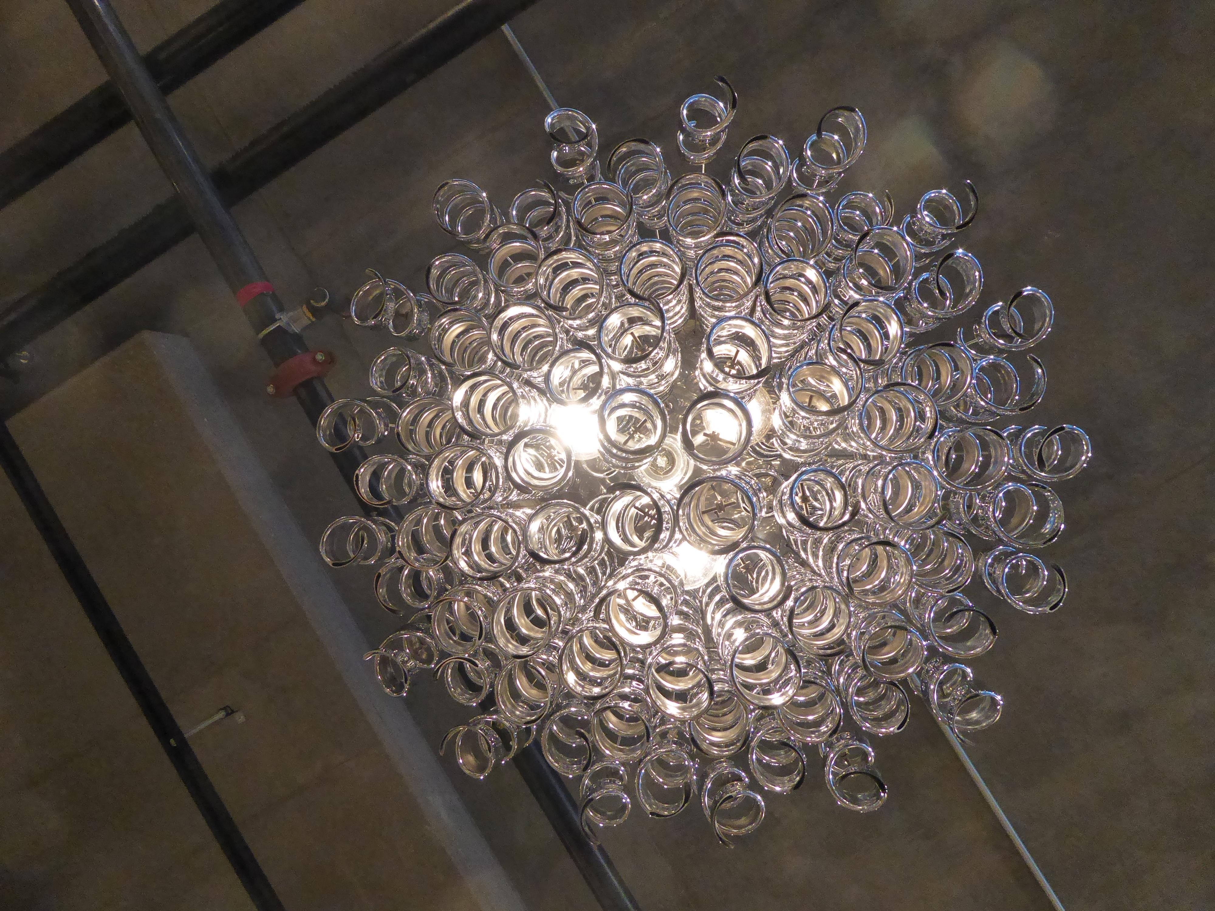 An unconventional chrome-plated metal chandelier made by Italian manufacturer, Zero Quattro in the 1970s. Very much in the style of Verner Panton, the 
metal 