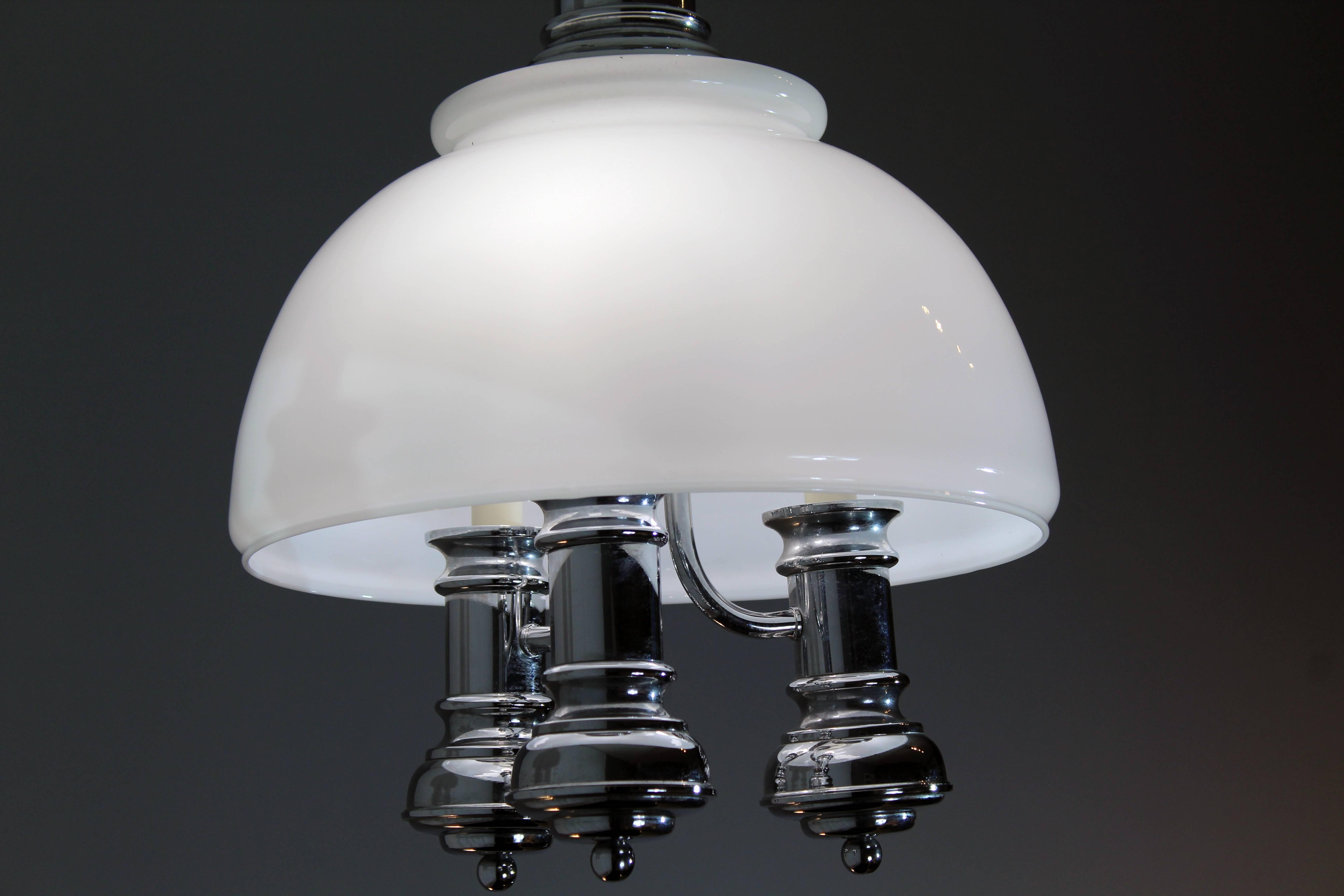 Chromed pendant with three cylindrical arms and a white glass lampshade. 
Made in Italy, circa 1970.