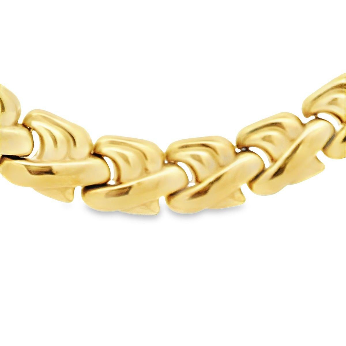 Ajoutez la touche finale avec notre collier de déclaration de fabrication italienne offert par Alex & Co. Cette pièce à porter partout en or jaune 14 carats, Circa 1980, présente un motif abstrait en forme de 