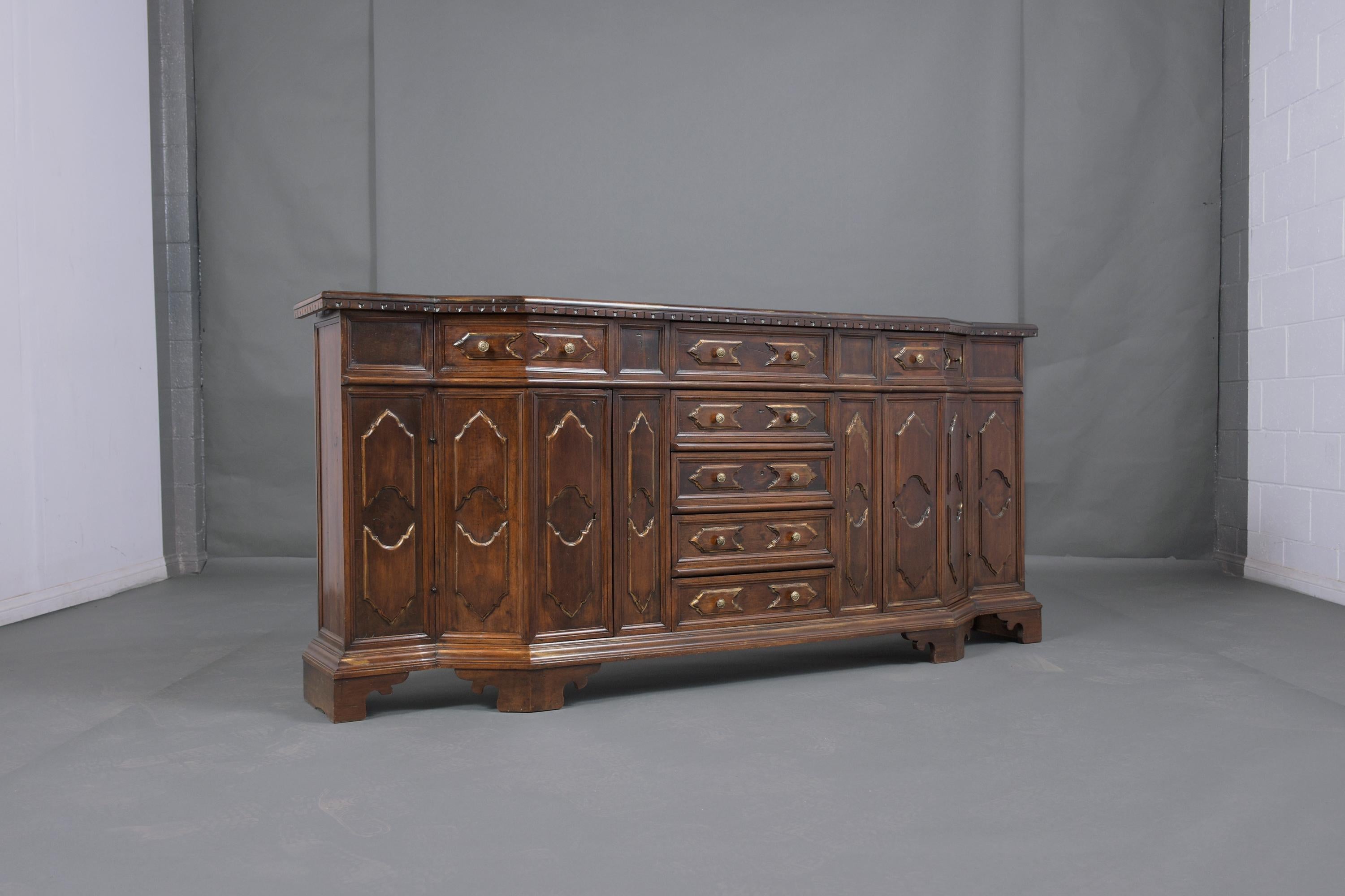 Immerse yourself in the grandeur of our Antique Baroque Buffet, a hand-crafted masterpiece made from premium walnut, and meticulously restored by our expert in-house craftsmen. This server exudes elegance and history, showcasing its original dark
